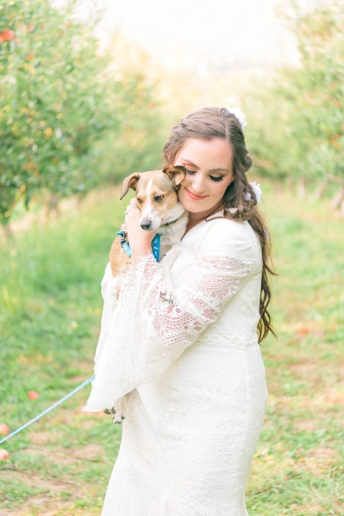 A bride who was able to keep her white dress clean even while holding her puppies with help from her wedding day emergency bag.