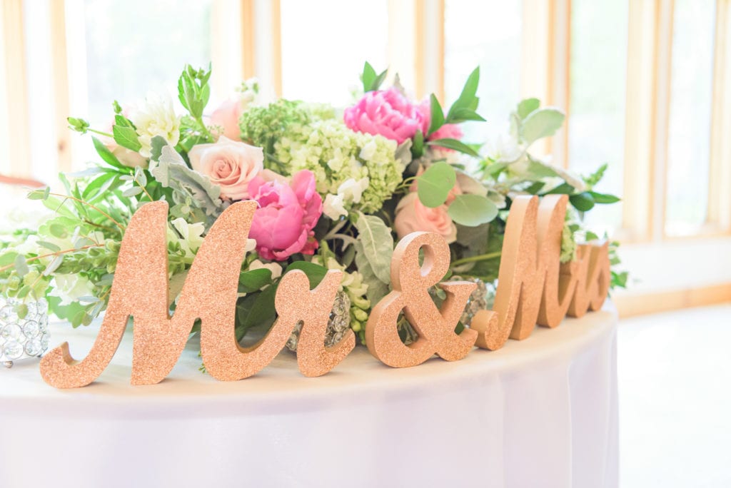 Flowers and a sparkly decoration that says “Mr. and Mrs.”