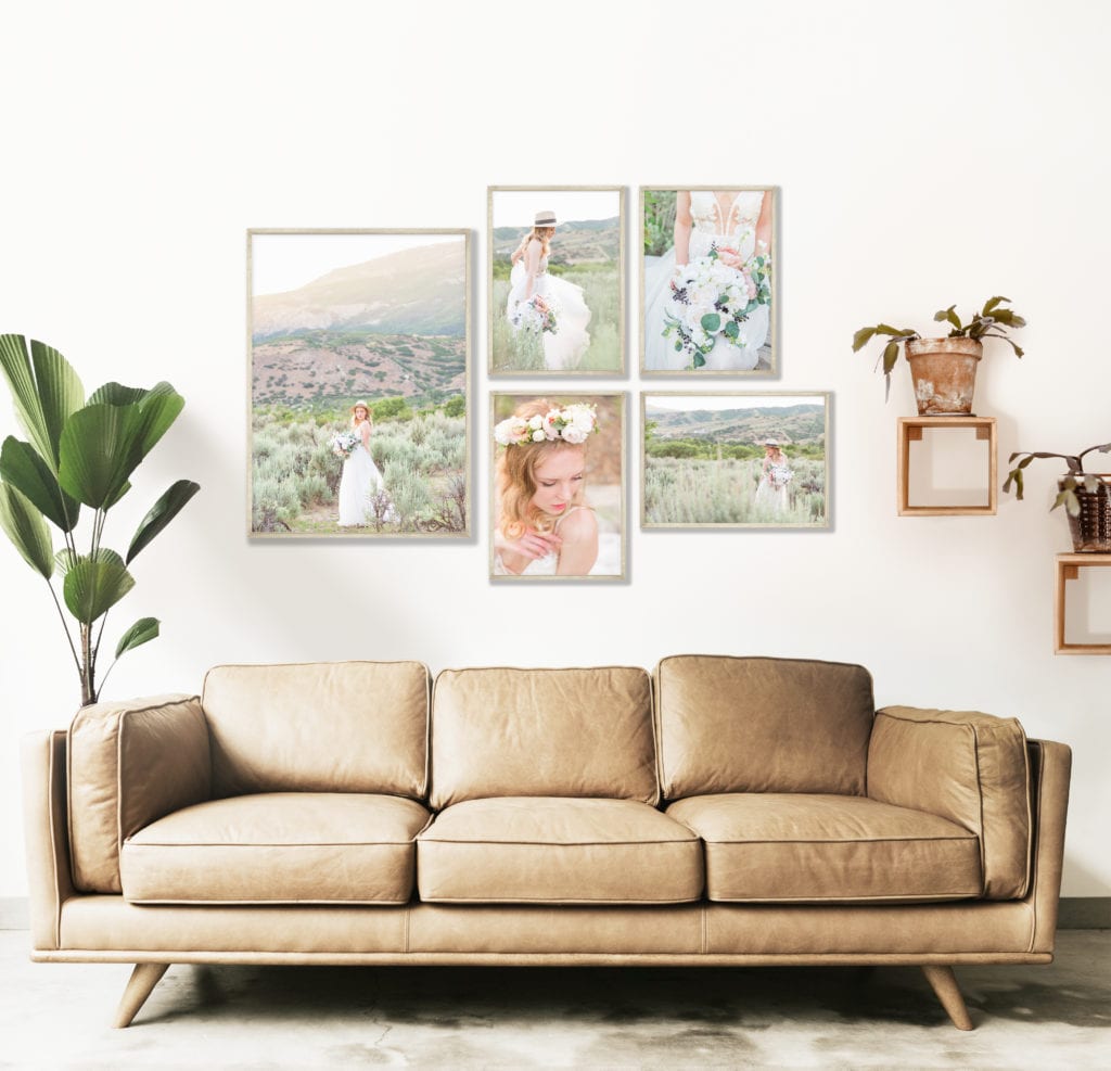 The wall above a tan couch is adorned with 5 hanging prints of a bridal session.