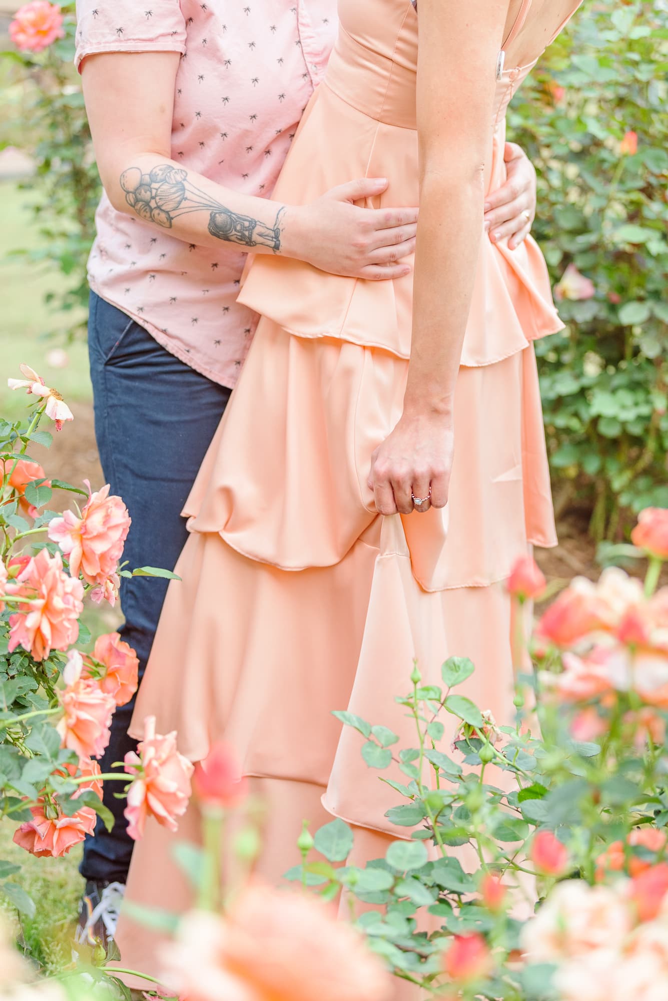 Pink roses in spring engagement photos.