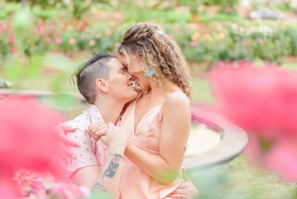 LGBT spring engagement photos, surrounded by roses.