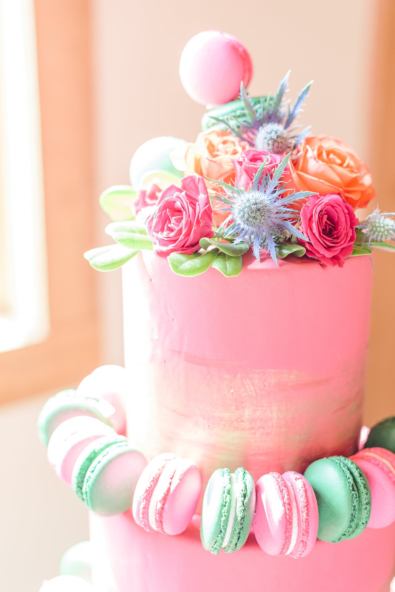 This Belmont NC wedding venue had a gorgeous three tiered pink cake decorated with macarons.
