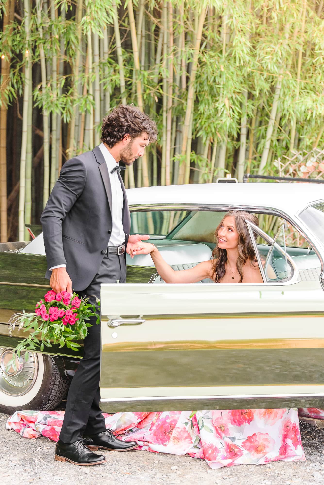 Trevor helps Kaelyn out of a green Cadillac car at a Belmont NC wedding venue.