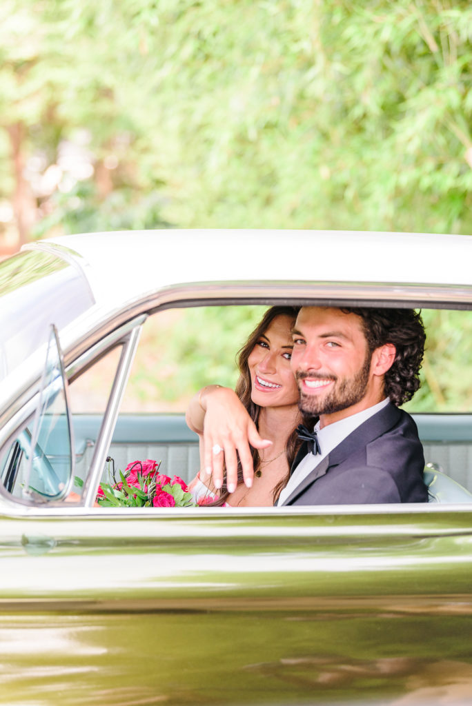 Kaelyn shows off her ring as her and Trevor hop into their getaway car at their end of their Belmont, NC wedding.