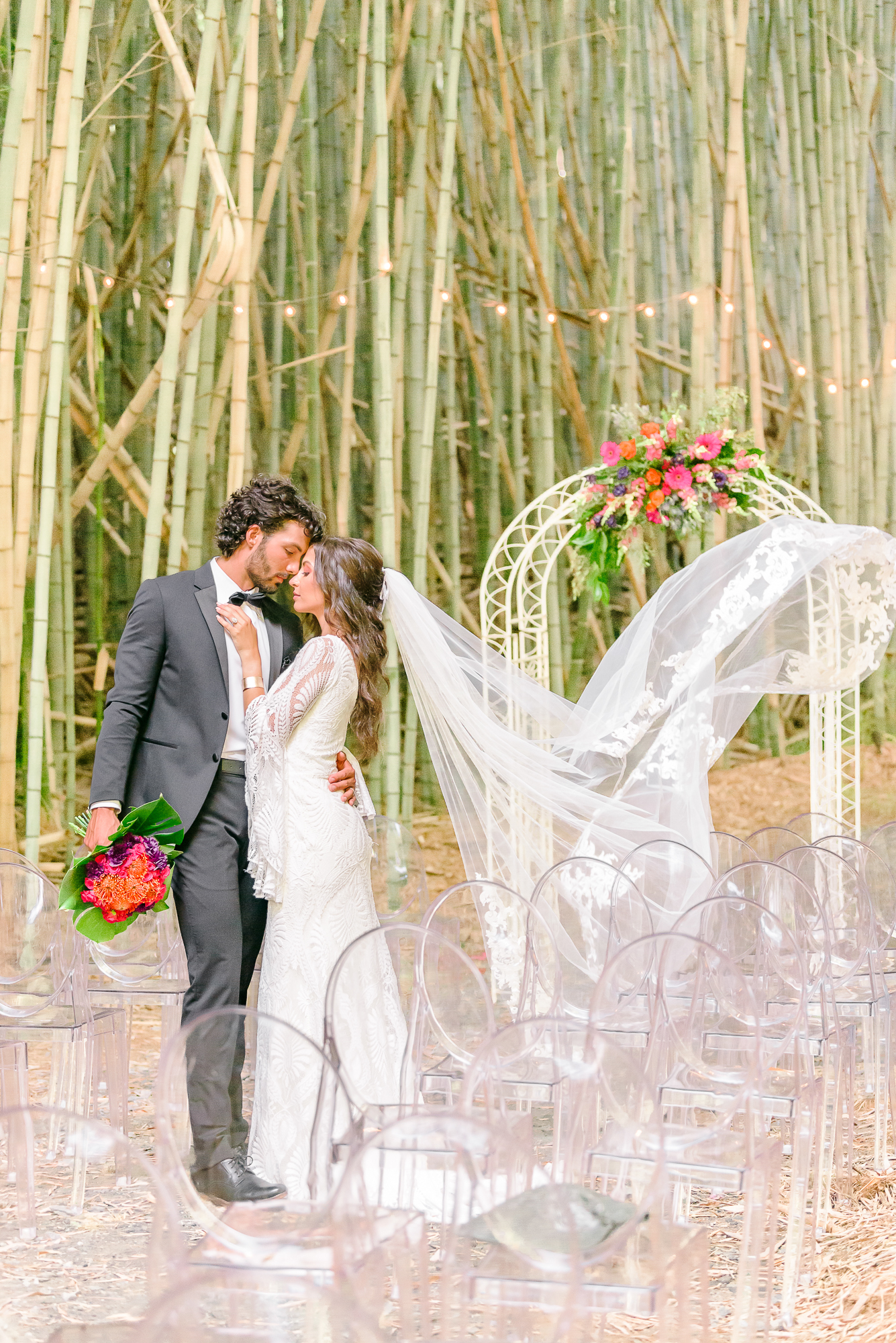 At this Belmont NC wedding venue, Kaelyn's veil blows in the wind behind her as she snuggles up to Trevor.