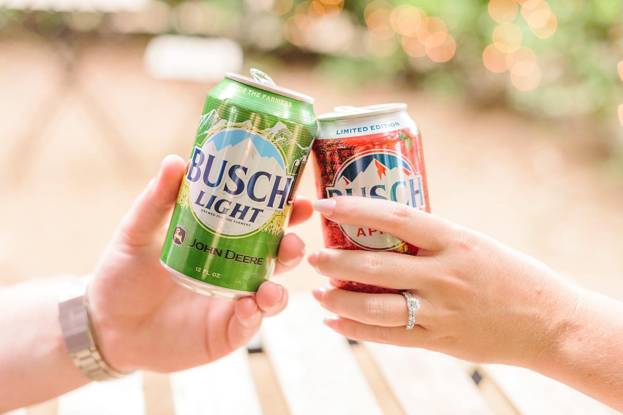During their Charlotte rose garden engagement session, Danielle and Phillip toasted to their engagement with cans of Busch Light.