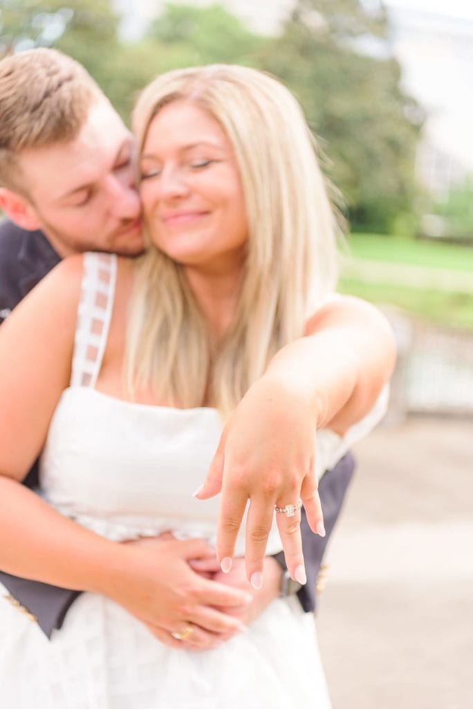 Heather shows off her new engagement ring as Corey hugs her at Marshall Park in Charlotte.