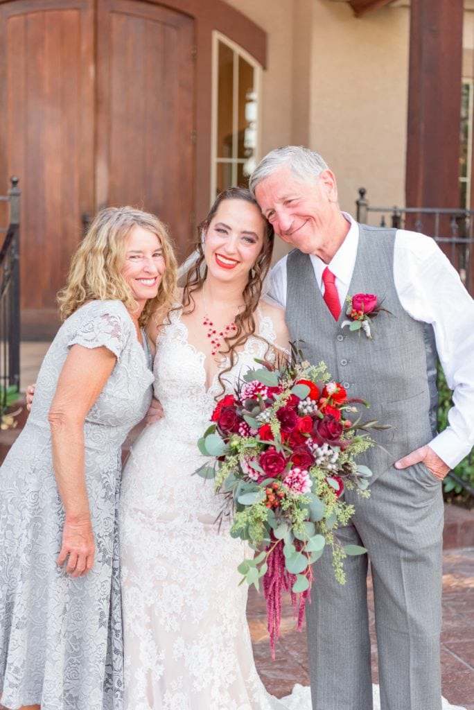 During the family photos at her wedding, Mia takes some time to get a photo with her parents.
