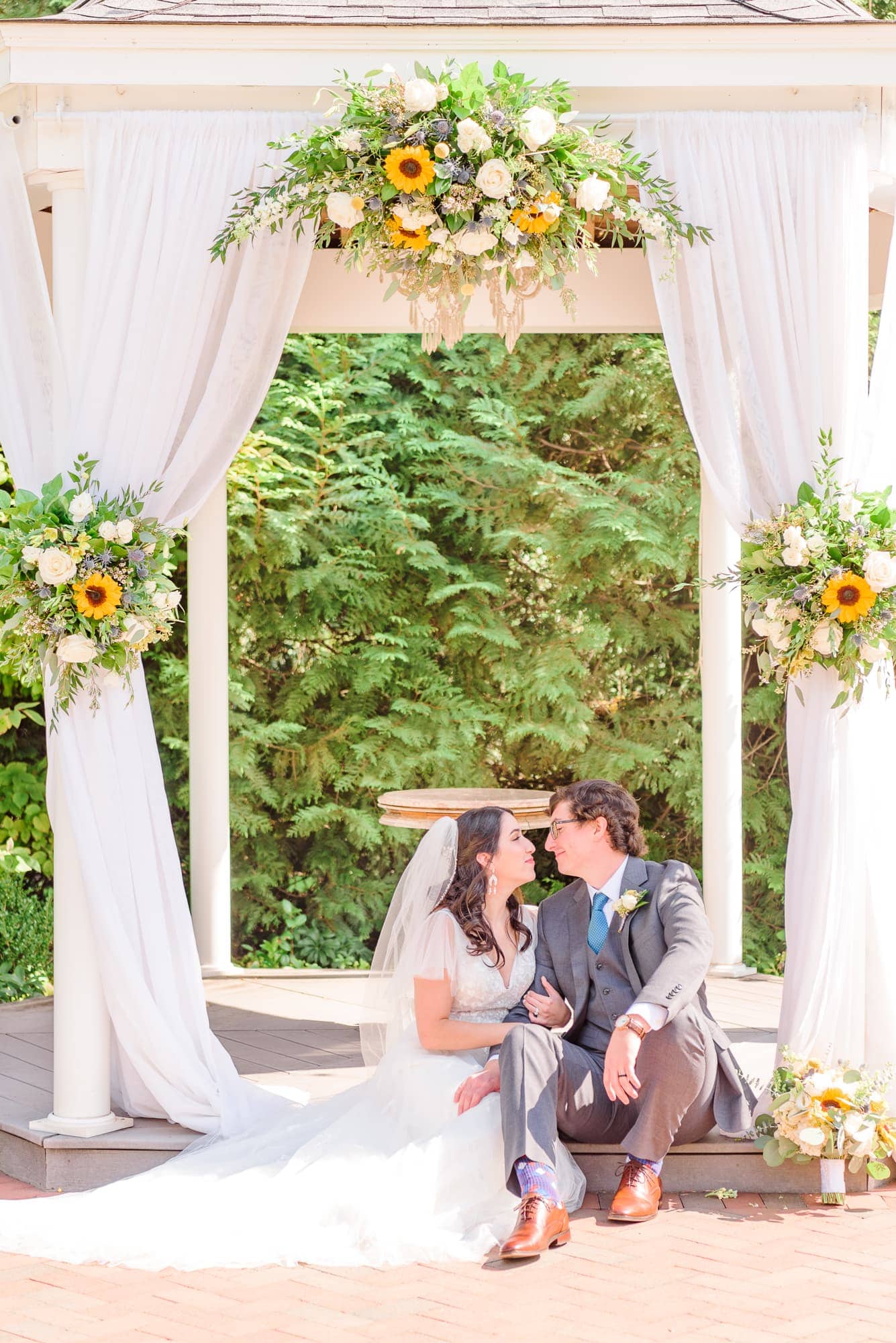 Natalie and Tommy take a quiet moment together under the gazebo arch at Alexander Homestead.