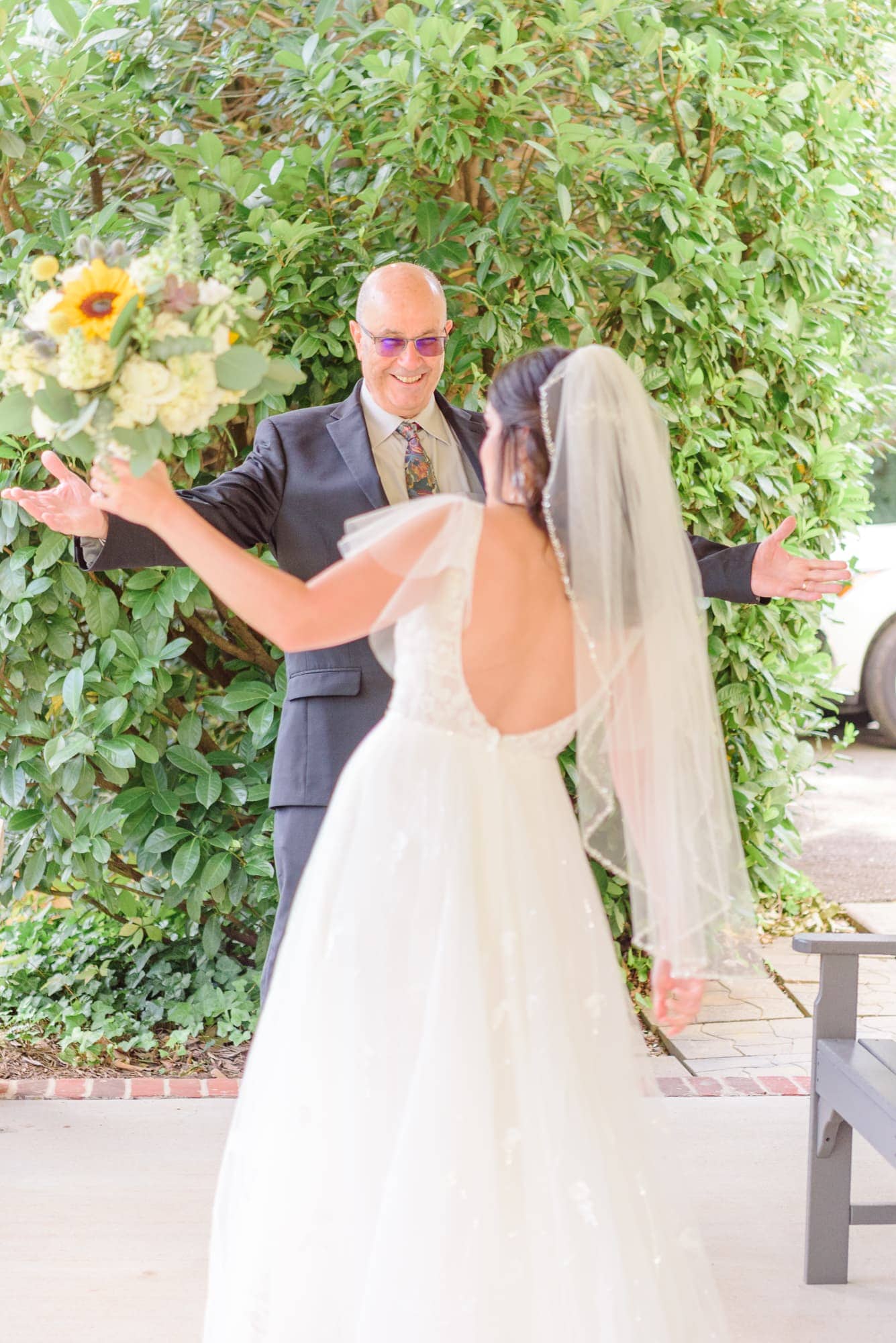 Dad sees his daughter as a bride for the first time at Alexander Homestead and a big smile breaks across his face.