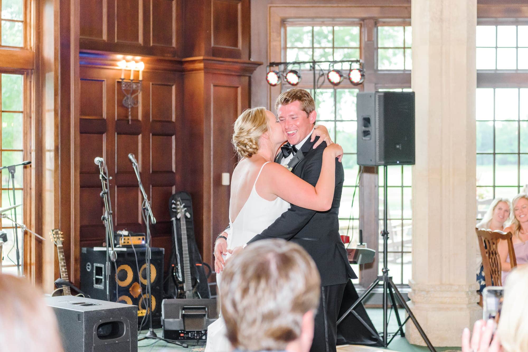 Casey looks ecstatic as Lauren kisses his cheek during their first dance at the Longview Country Club in Charlotte.