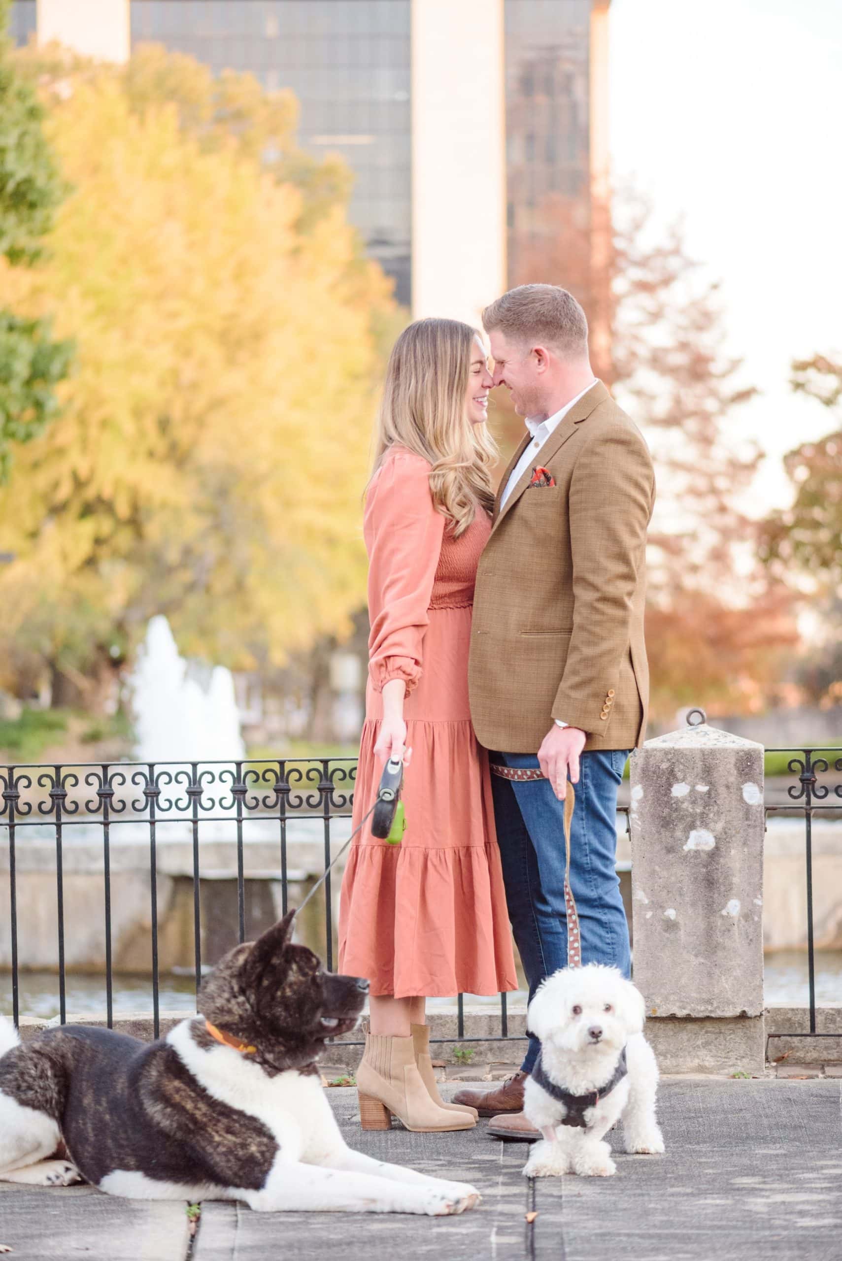 City engagement photos with a couple and their two dogs.