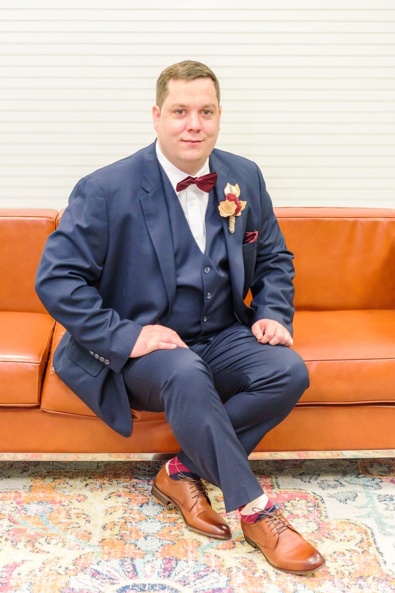 Jeff sits on an orange couch before his ceremony at the Charles Mack Citizen Center.