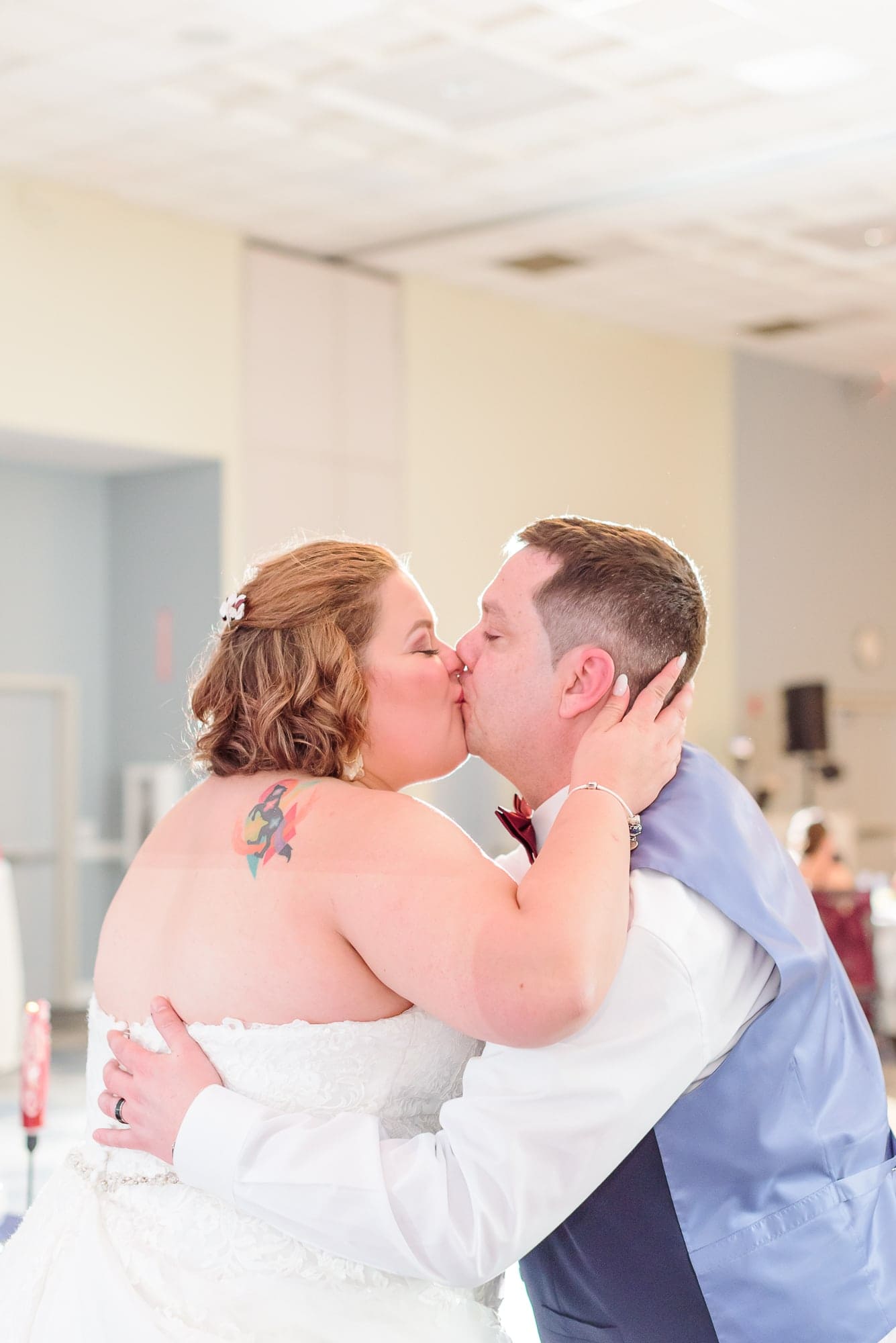 Yessie and Jeff kiss in the reception hall at the Charles Mack Citizen Center in Mooresville.