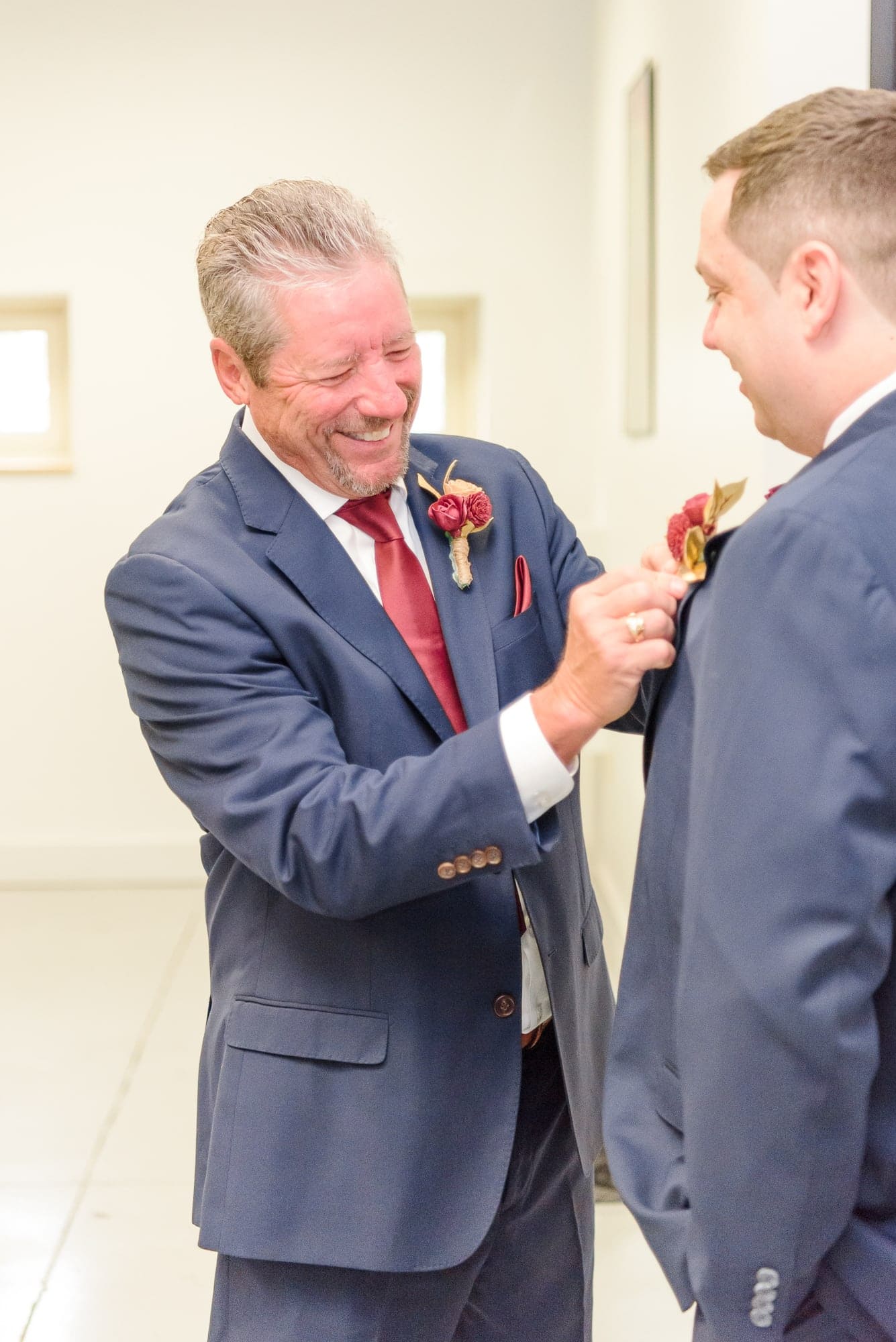 Jeff's dad helps him with his jacket in the groom's room of the Charles Mack Citizen Center.