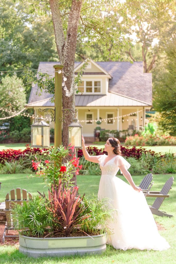 Natalie touches one of the trees at Alexander Homestead during her bridal portraits.
