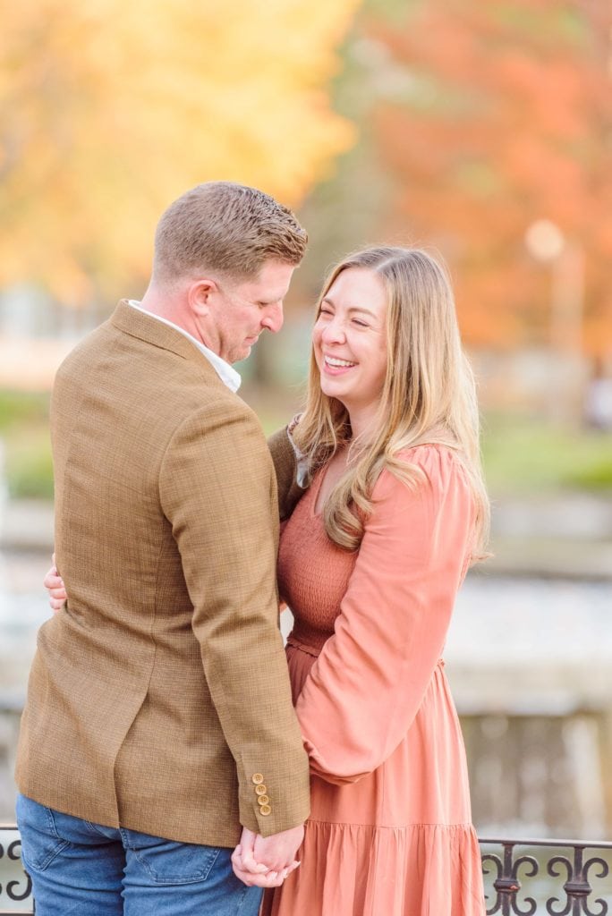 Kati laughs at Curtis during their city engagement photos in Charlotte.