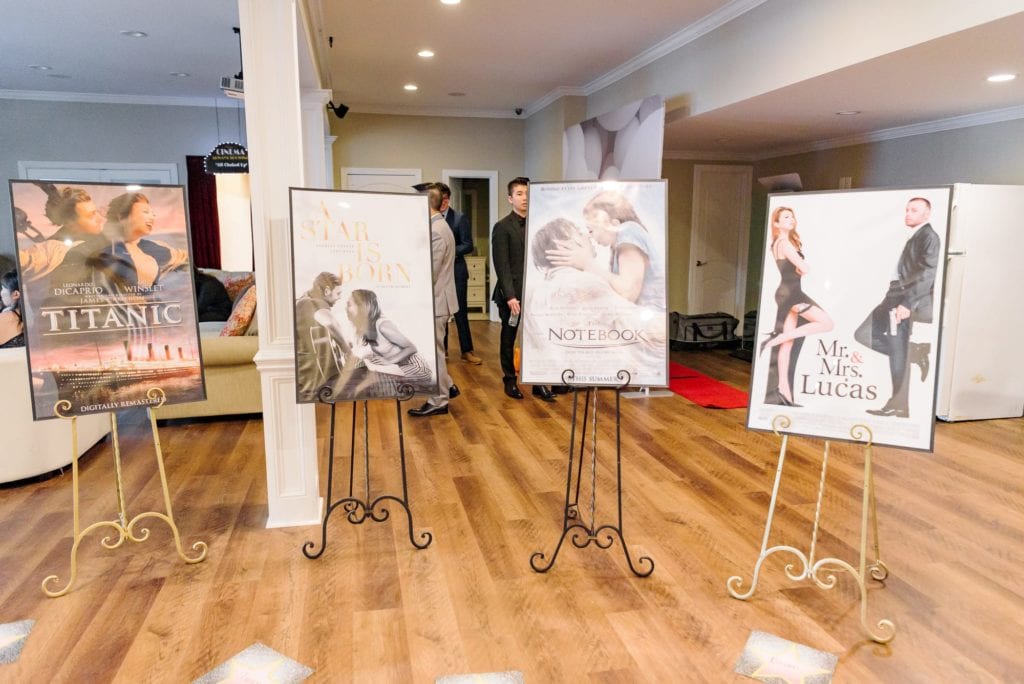 A Hollywood themed wedding reception with custom movie posters, except Seth and Ashley have been photoshopped as the main characters in each poster.