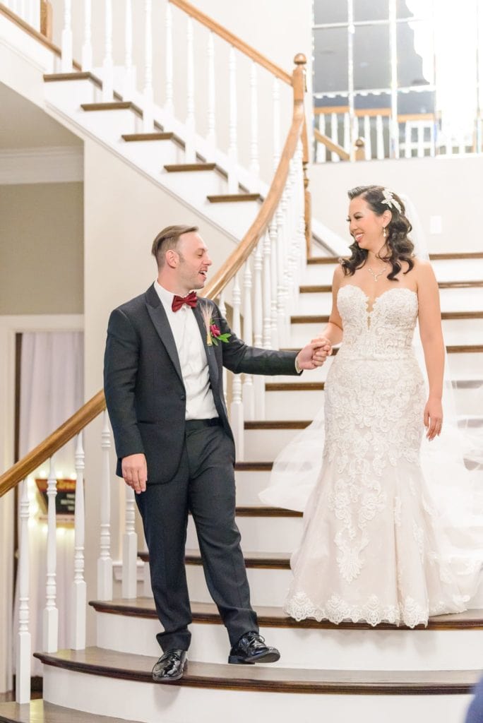 Seth and Ashley walk down the grand staircase hand in hand before they perform their duet at their Hollywood themed wedding.