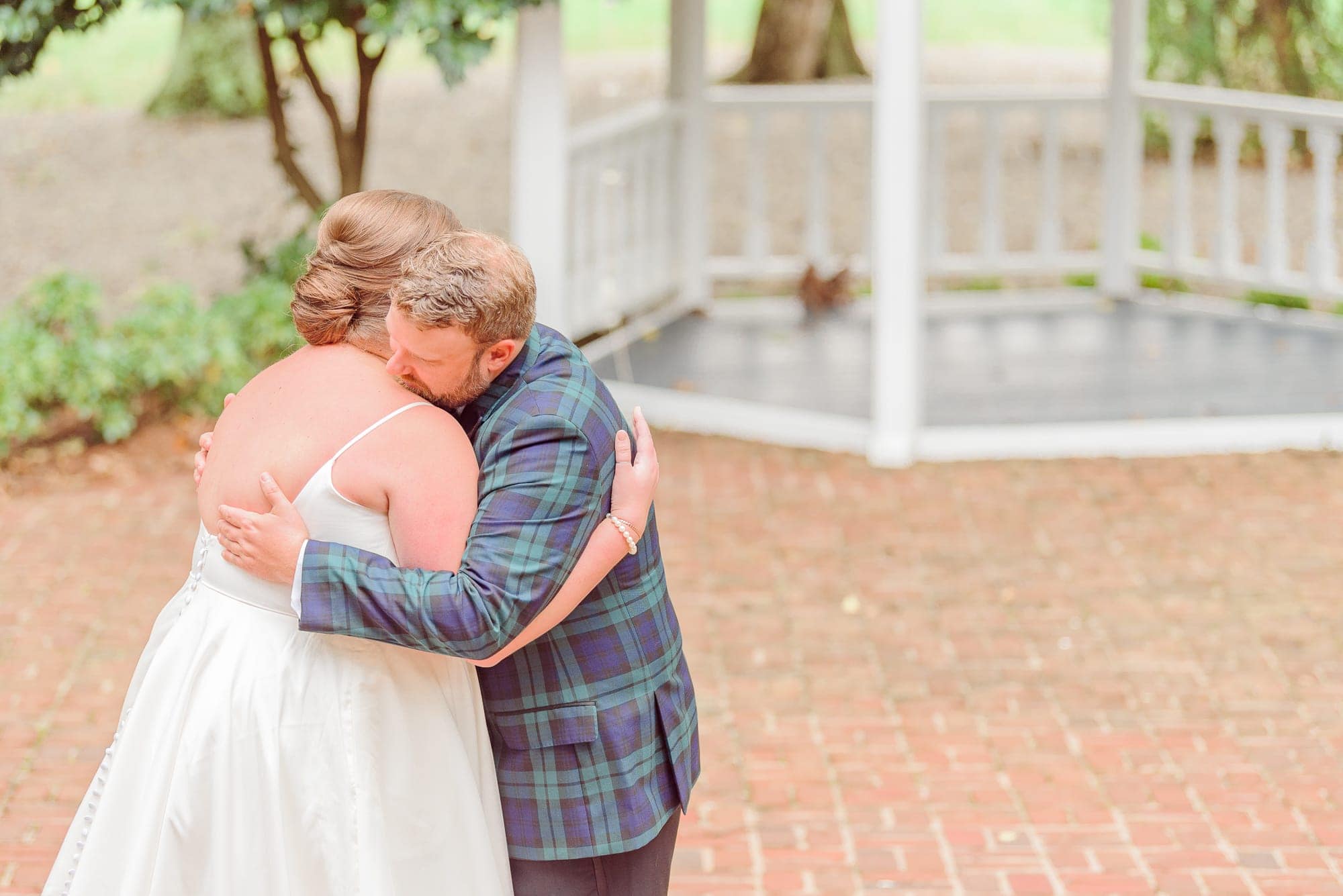Sarah and Ryan share a hug under the gazebo at the Whitehead Manor during their first look.