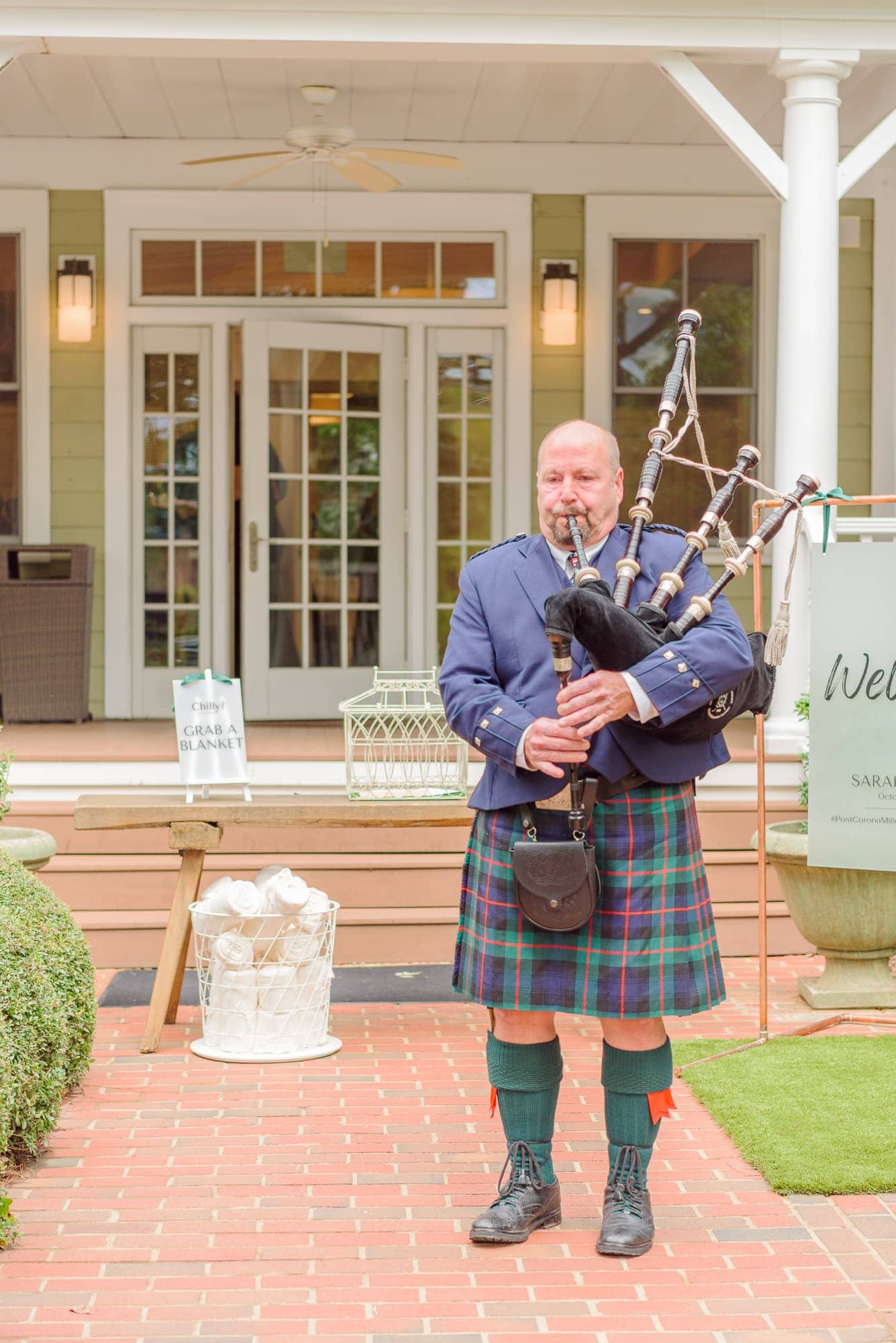 A bagpiper in traditional Scottish garb plays a welcome melody on the front steps of the Whitehead Manor.