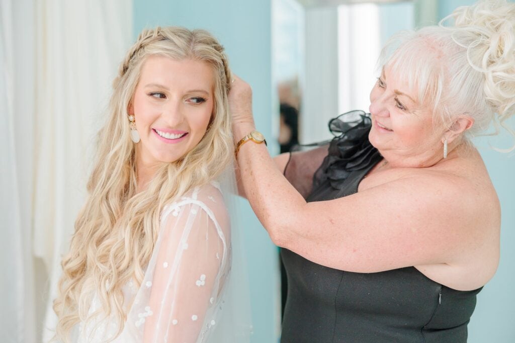 Before her wedding on the beach in North Carolina, Spencer's mom helps touch up her bridal hair.