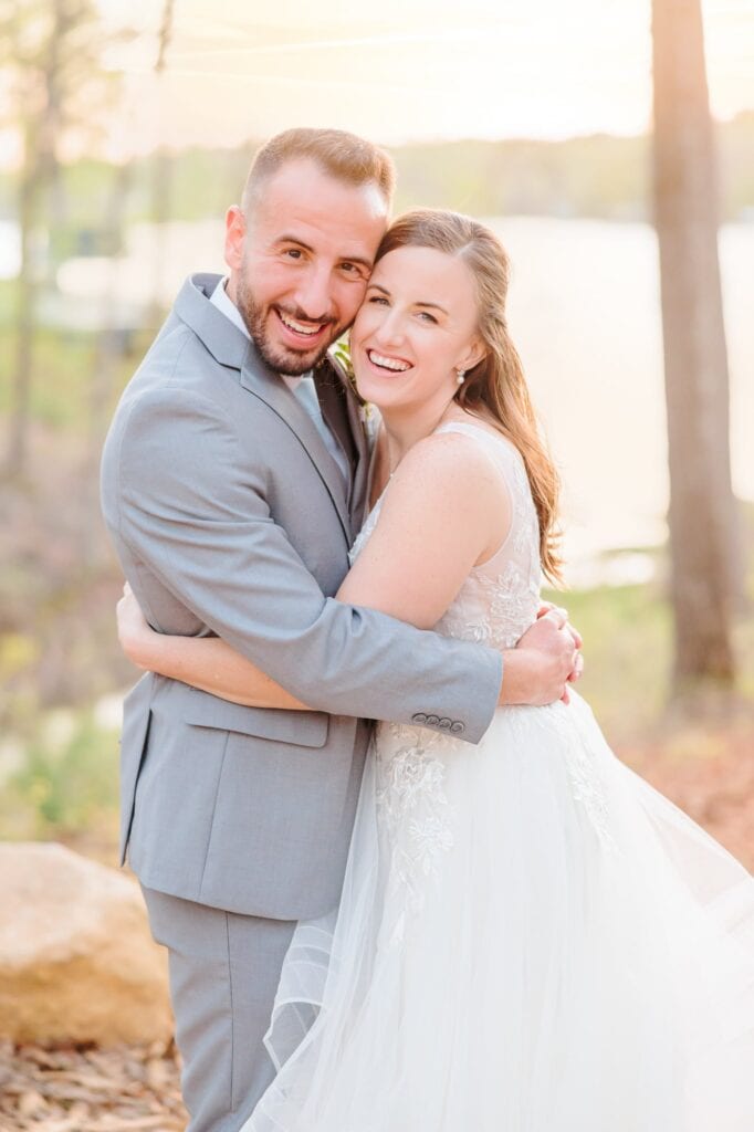 Joey and Alicia smile at the camera, happy after their beautiful outdoor wedding ceremony in North Carolina.