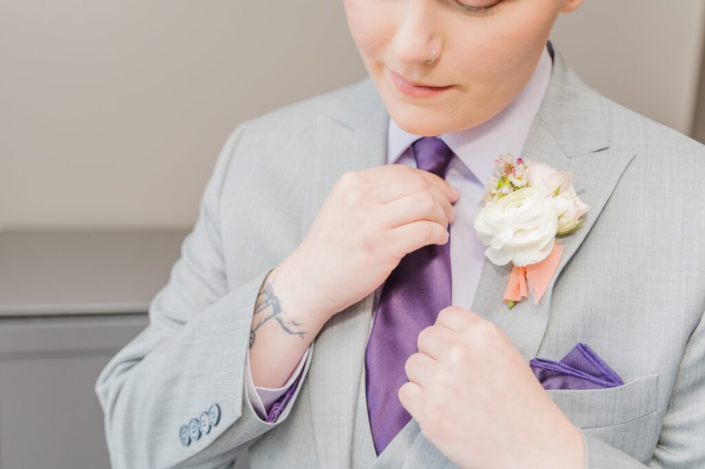 Veronica prepares for her wedding at the Bradford by adjusting her purple tie and boutonniere. 
