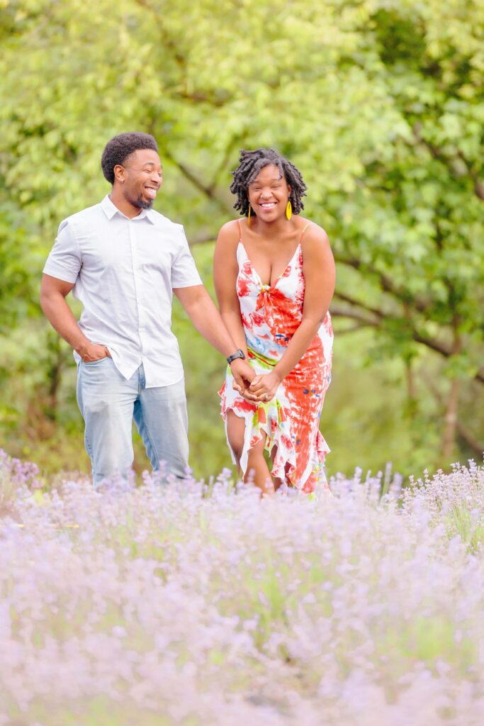 LaVianca and Shakim hold hands and walk through the fields of lavender at this farm in NC.