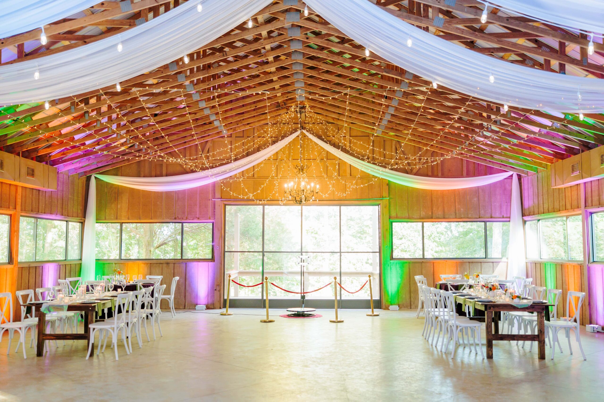 The large wedding hall has different colored lights lighting up the walls on all sides to keep with the disco theme.