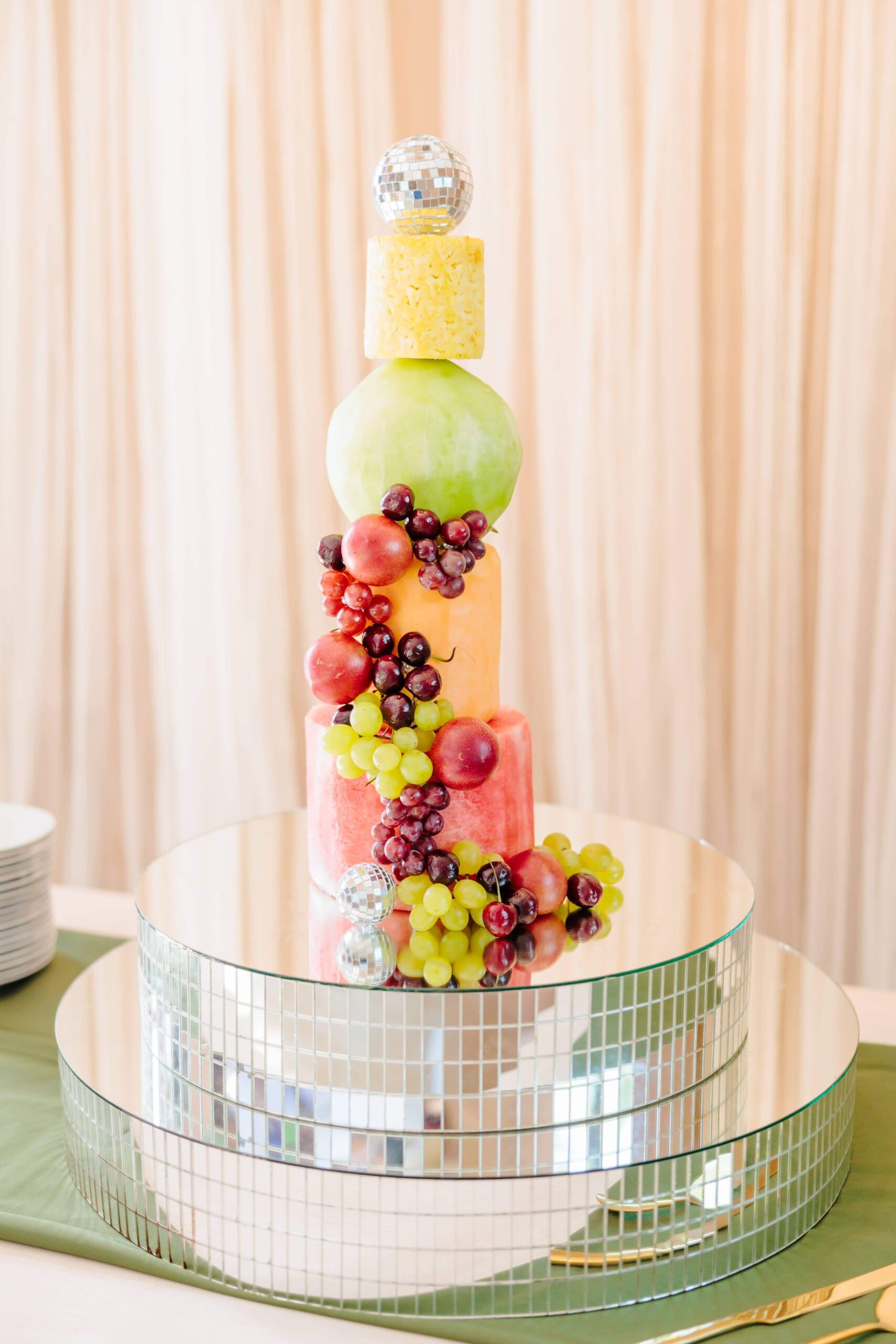 This disco wedding cake was made entirely of shaved fruit. Grapes and tiny disco balls cascade down the side of the cake.