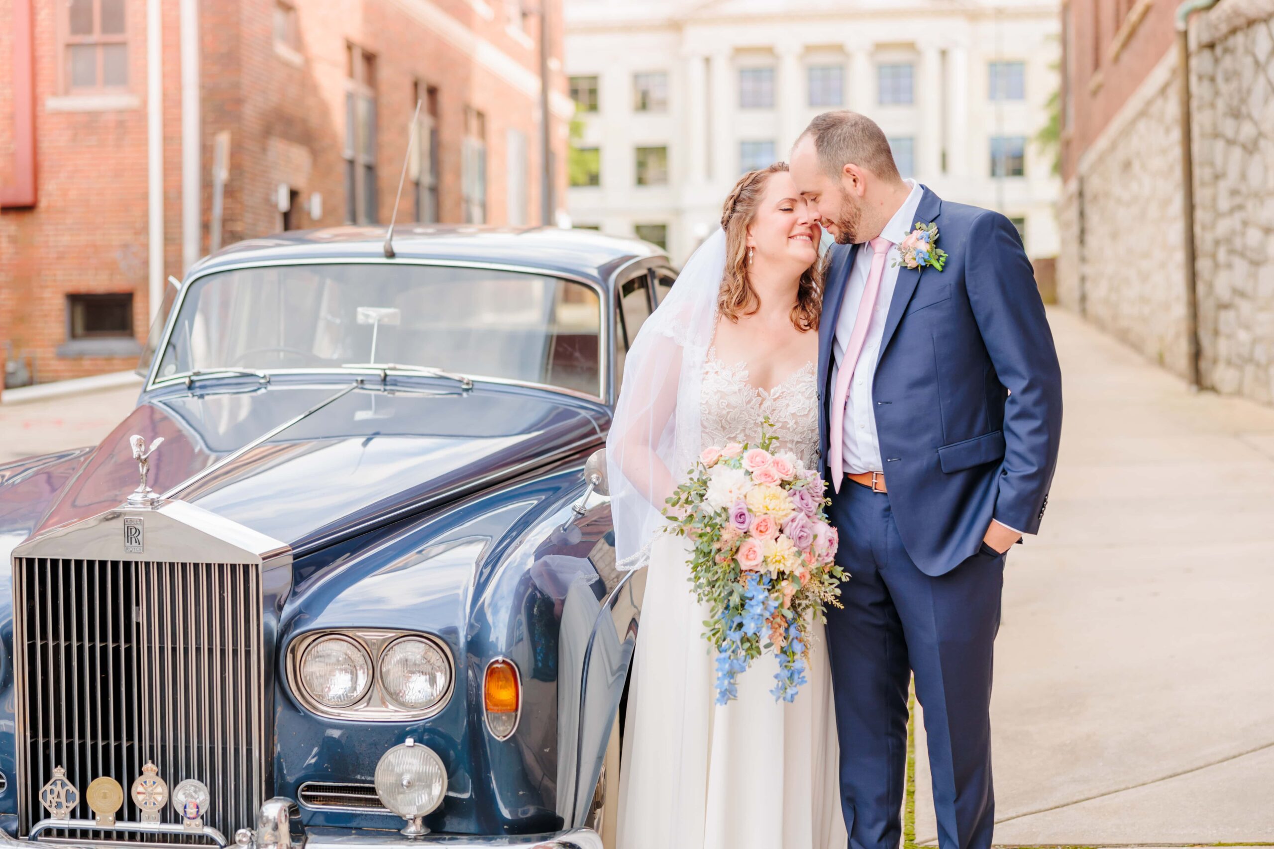 Emelia and Wakefield smile closely at each other in downtown Greensboro, NC after their wedding.