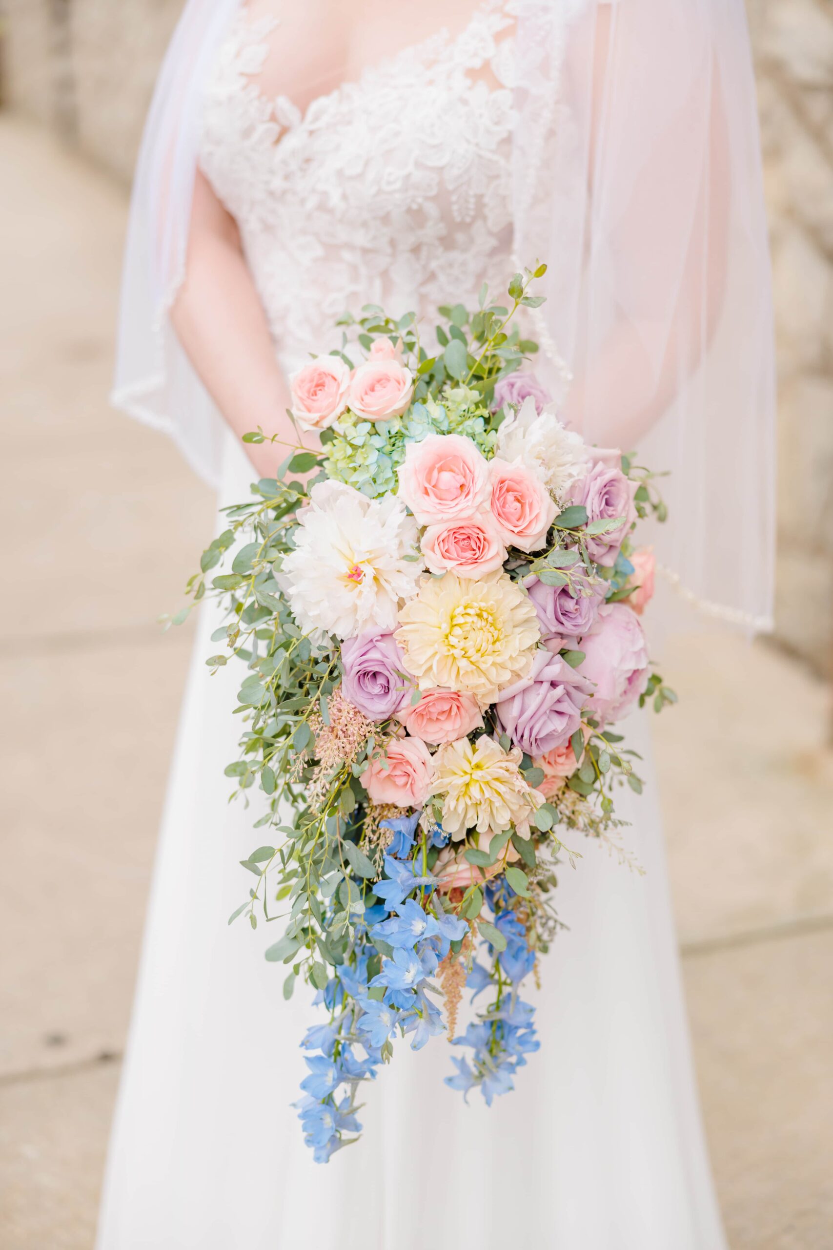 This Greensboro wedding had the bride holding a cascading flower bouquet with lots of pastel colors.