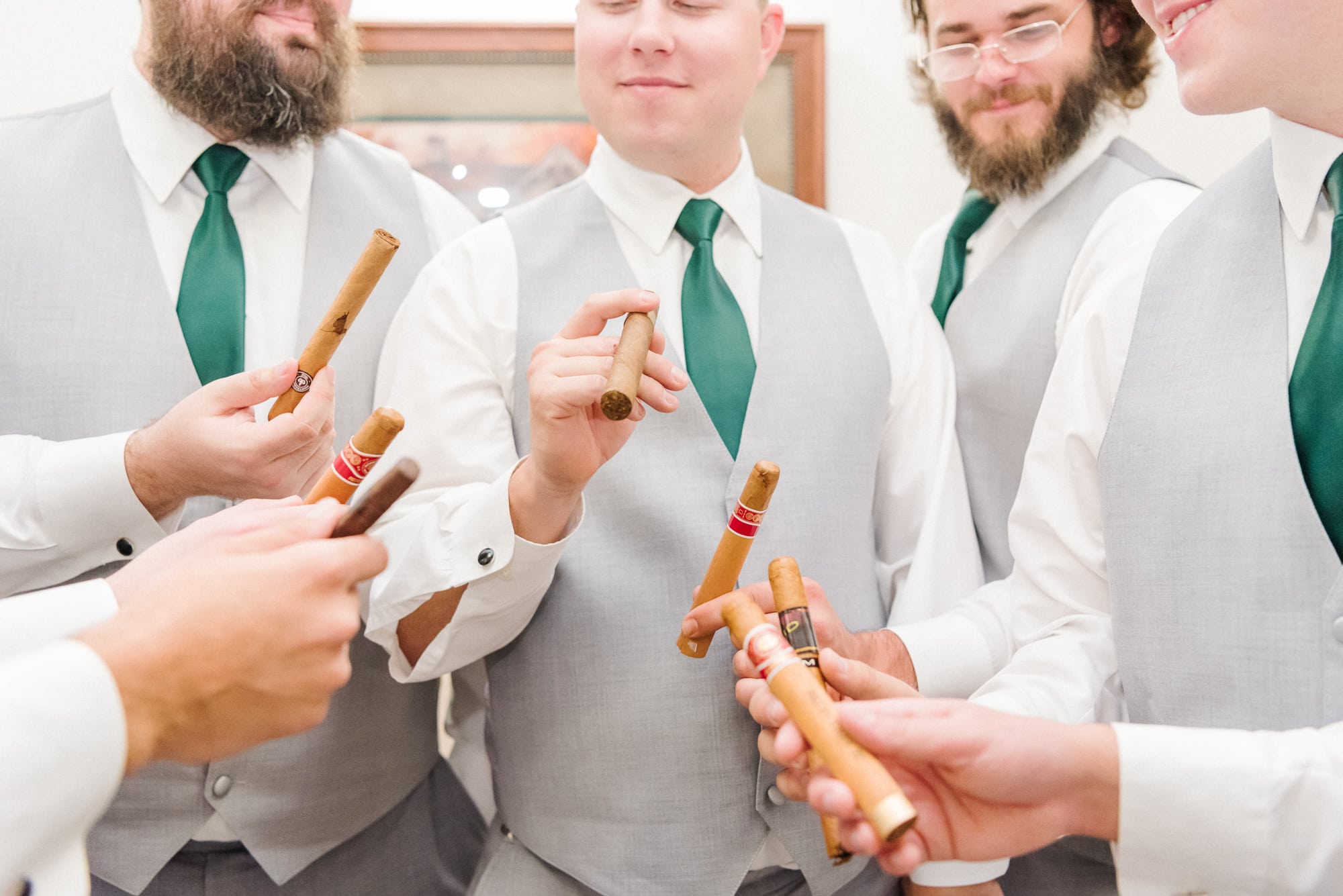 Alec and his groomsmen hold their cigars in a huddle in the groom's room at Low Meadows Estate.