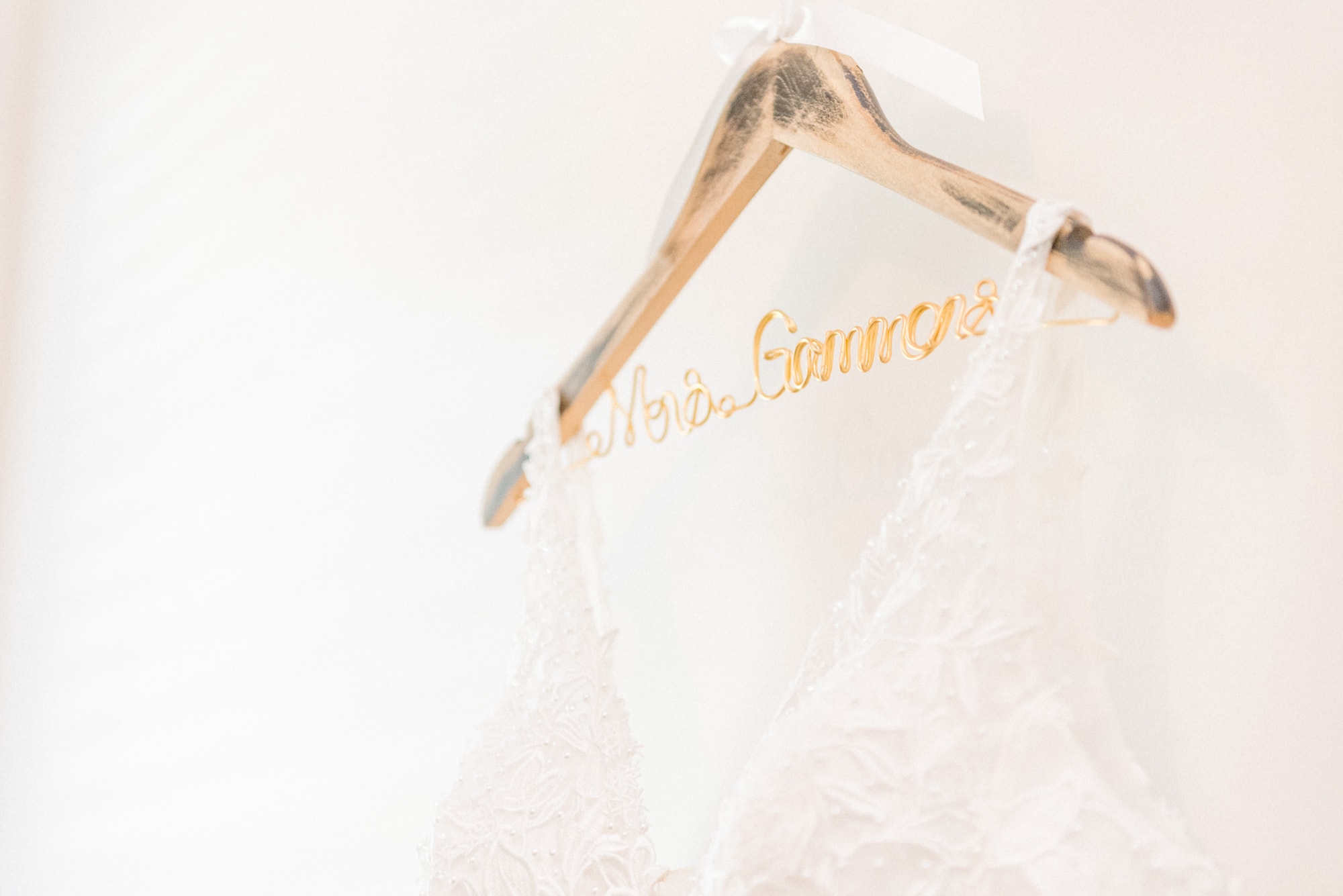 The hanger holding the bride's dress at Low Meadows Estate reads Mrs. Gammons in gold lettering.