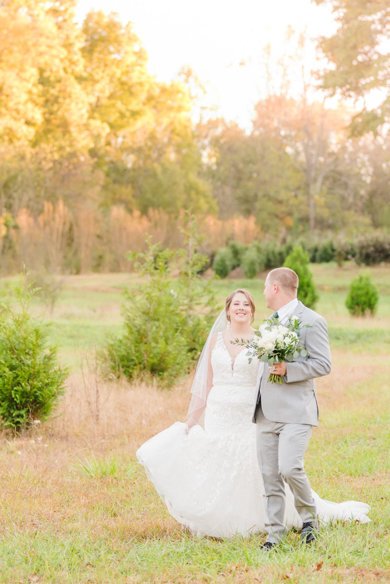 Katelynn and Alec walk through the field at Low Meadows Estate, hand in hand.