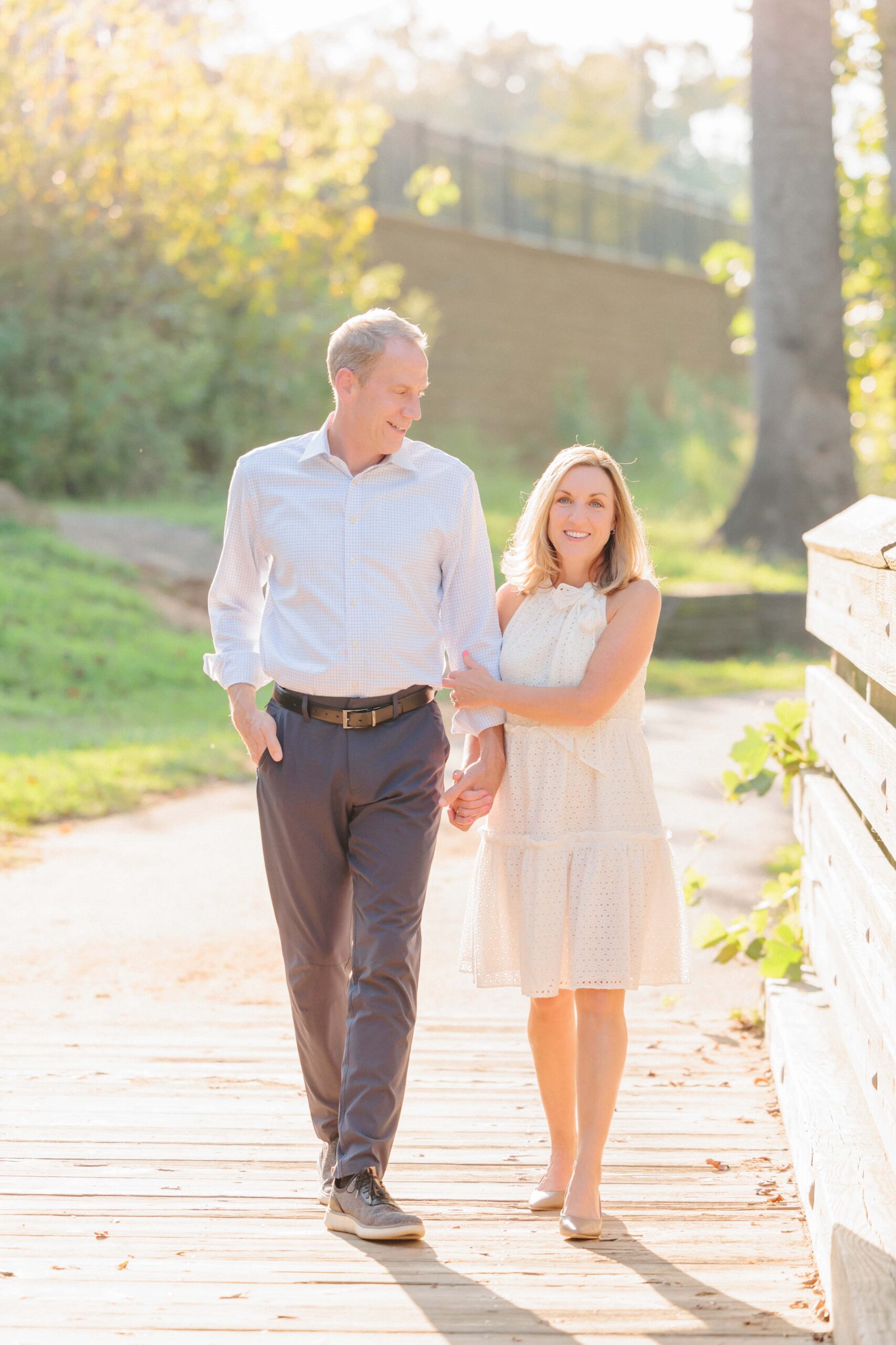 The beautiful engaged couple walks down the riverwalk path in Rock Hill, SC for this image.