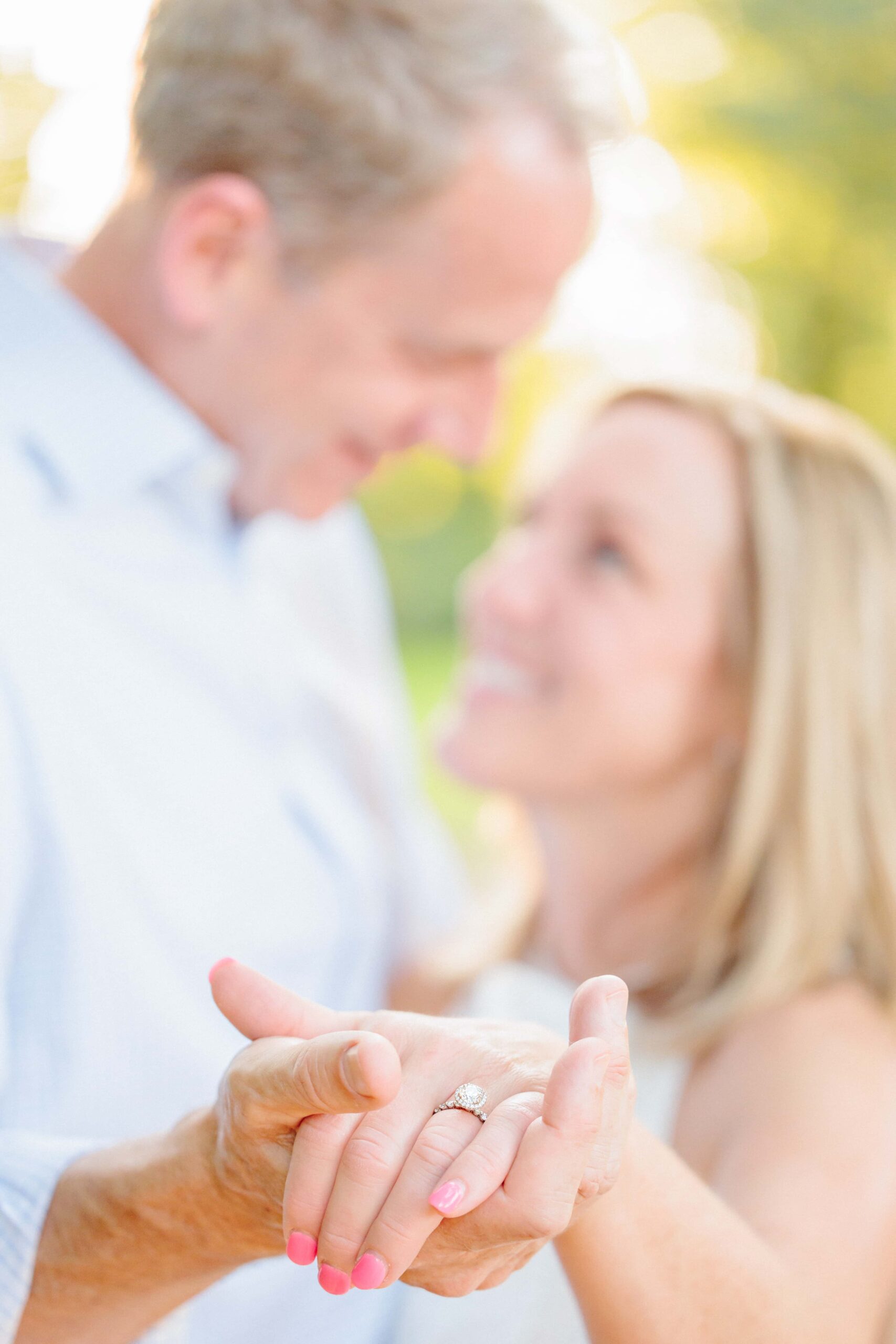 Janet and Matt show off her engagement ring as they dance together for this image at the Rock Hill, SC riverwalk.