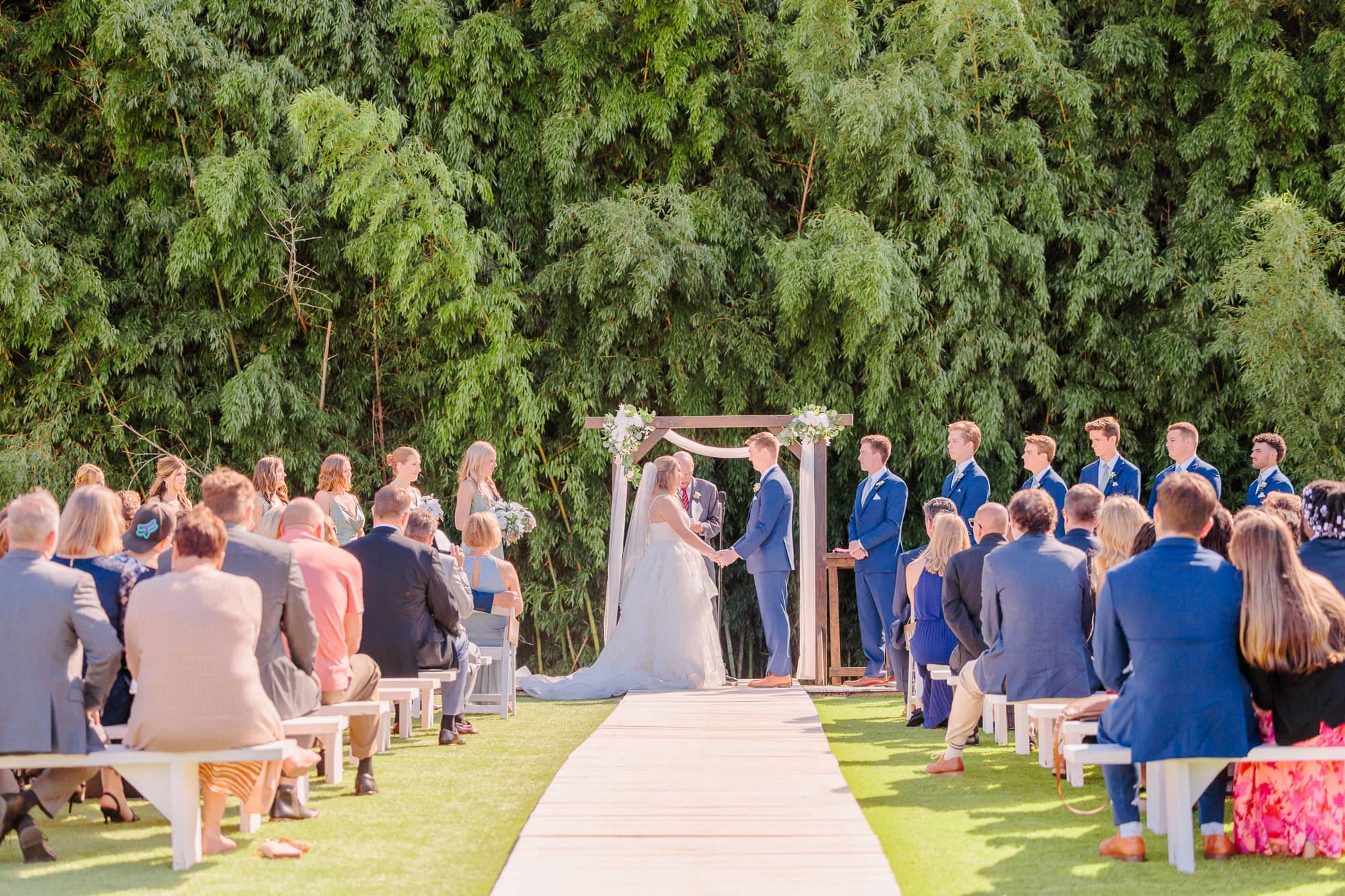 Even though they had a barn wedding venue, they held their ceremony in front of the bamboo forest.