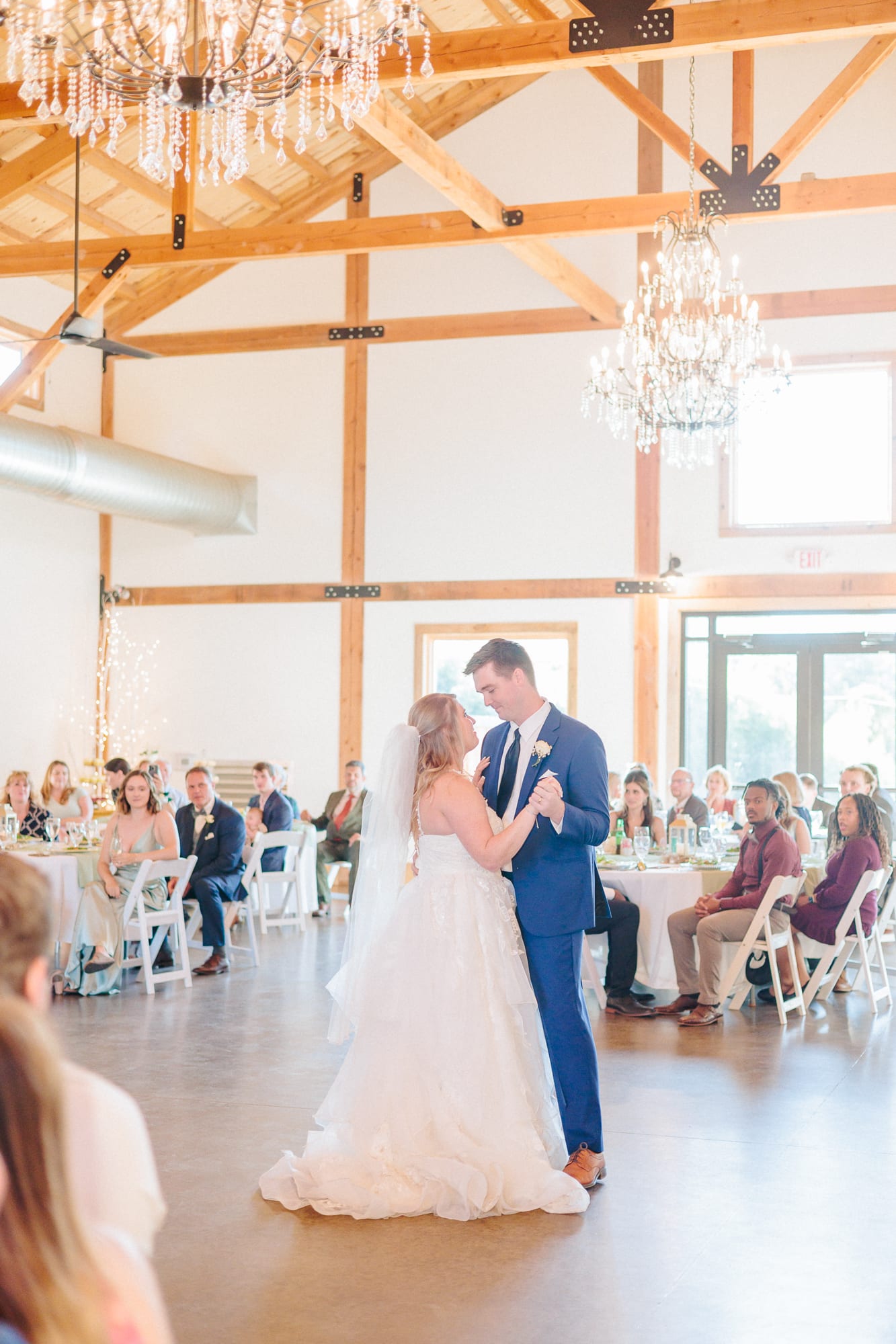 Conor and Becca enjoy their first dance inside of the barn at their wedding reception.