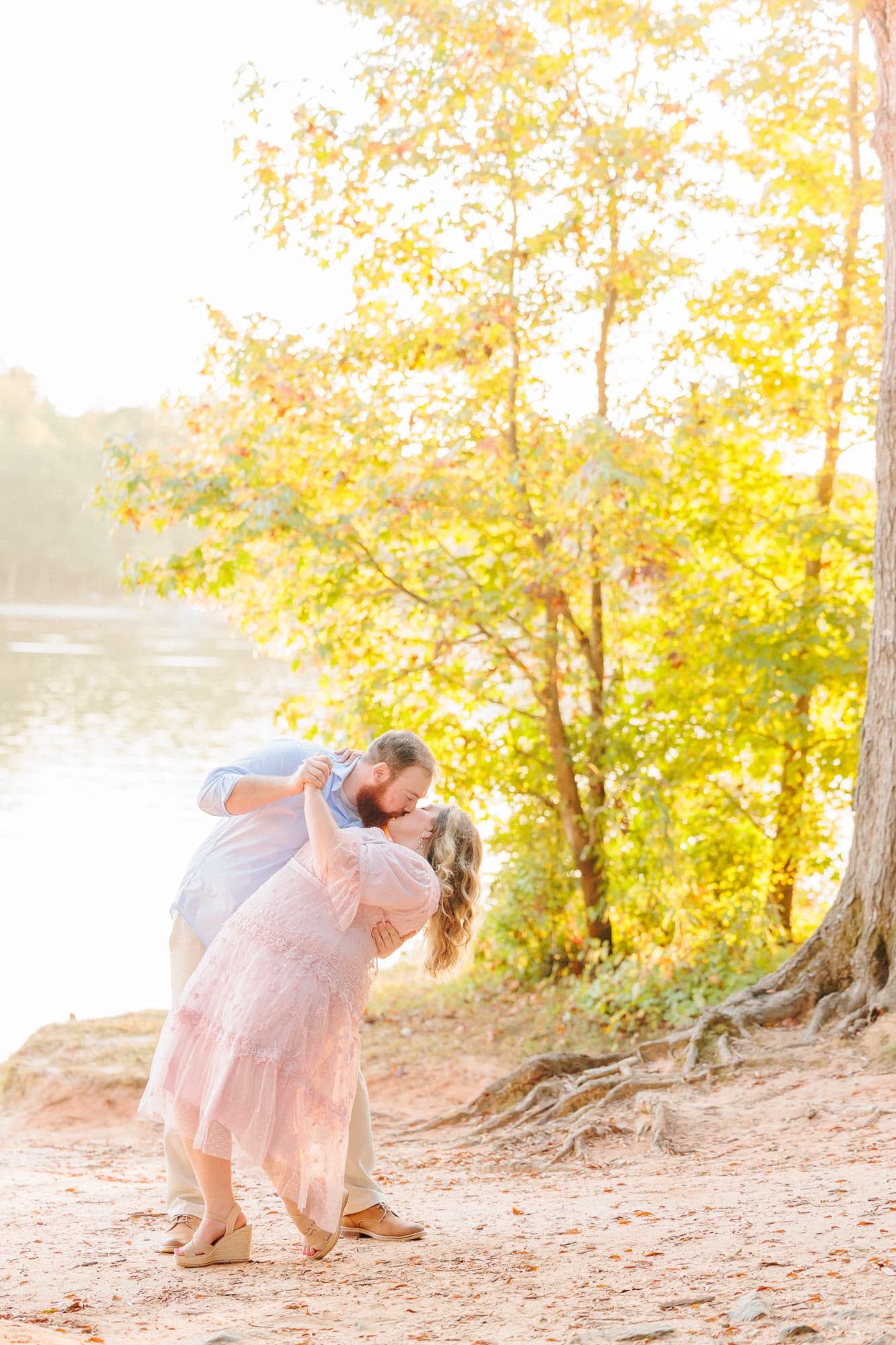 Shawn dips Shelby in a romantic kiss in Huntersville for their engagement photo session.