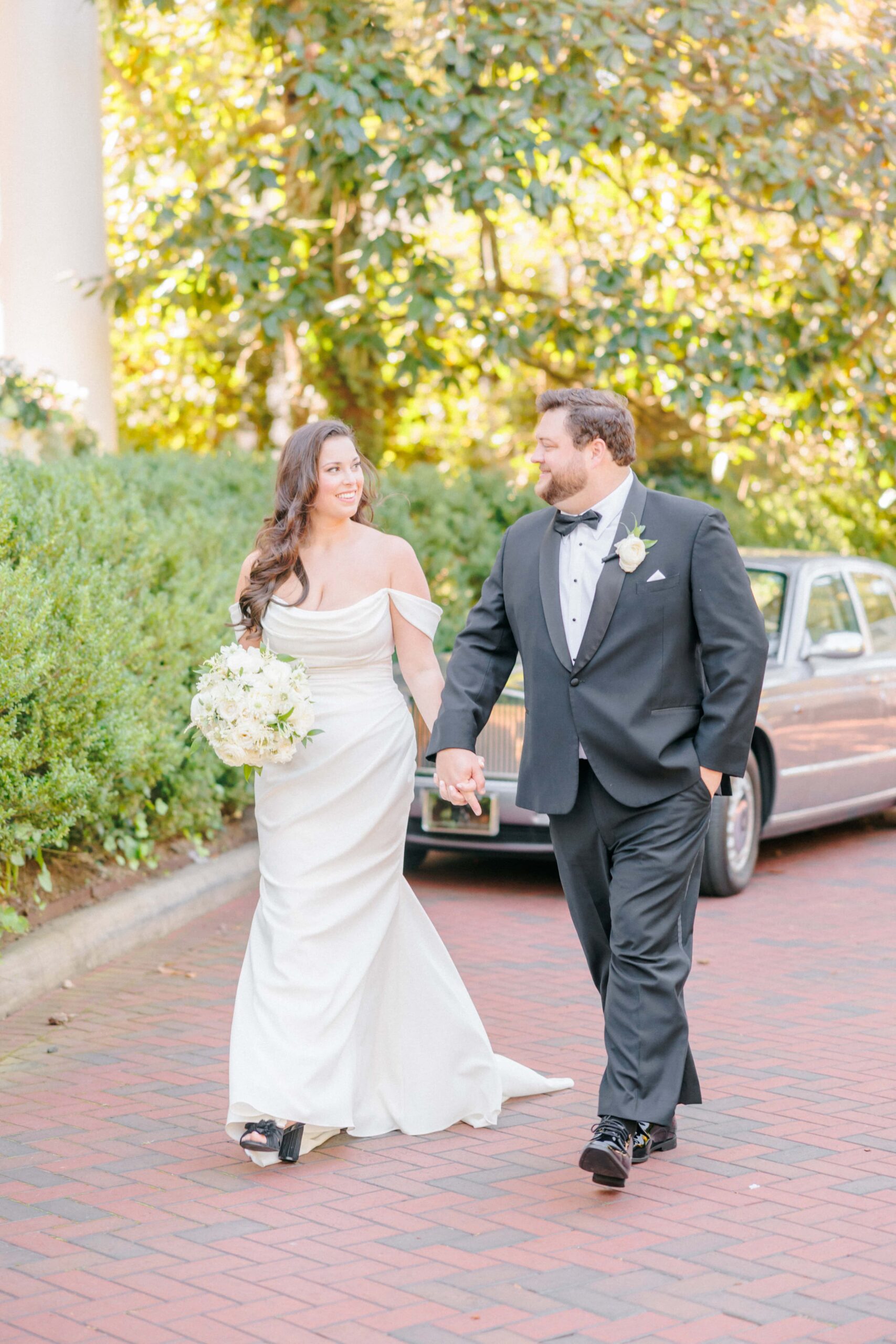 Wedding photos in front of the Duke Mansion with a classic car in the background.