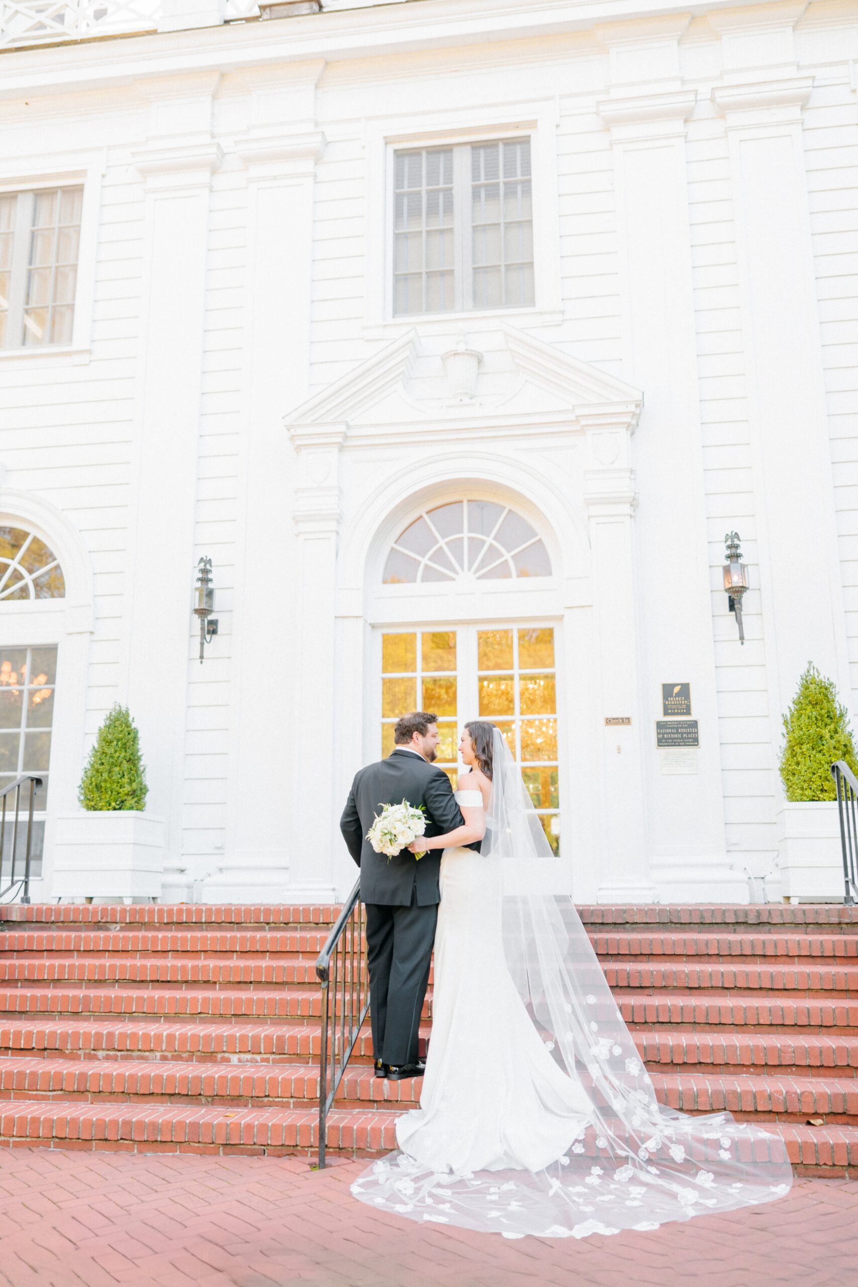 A bride and groom smile at each other for their Duke Mansion wedding photos.