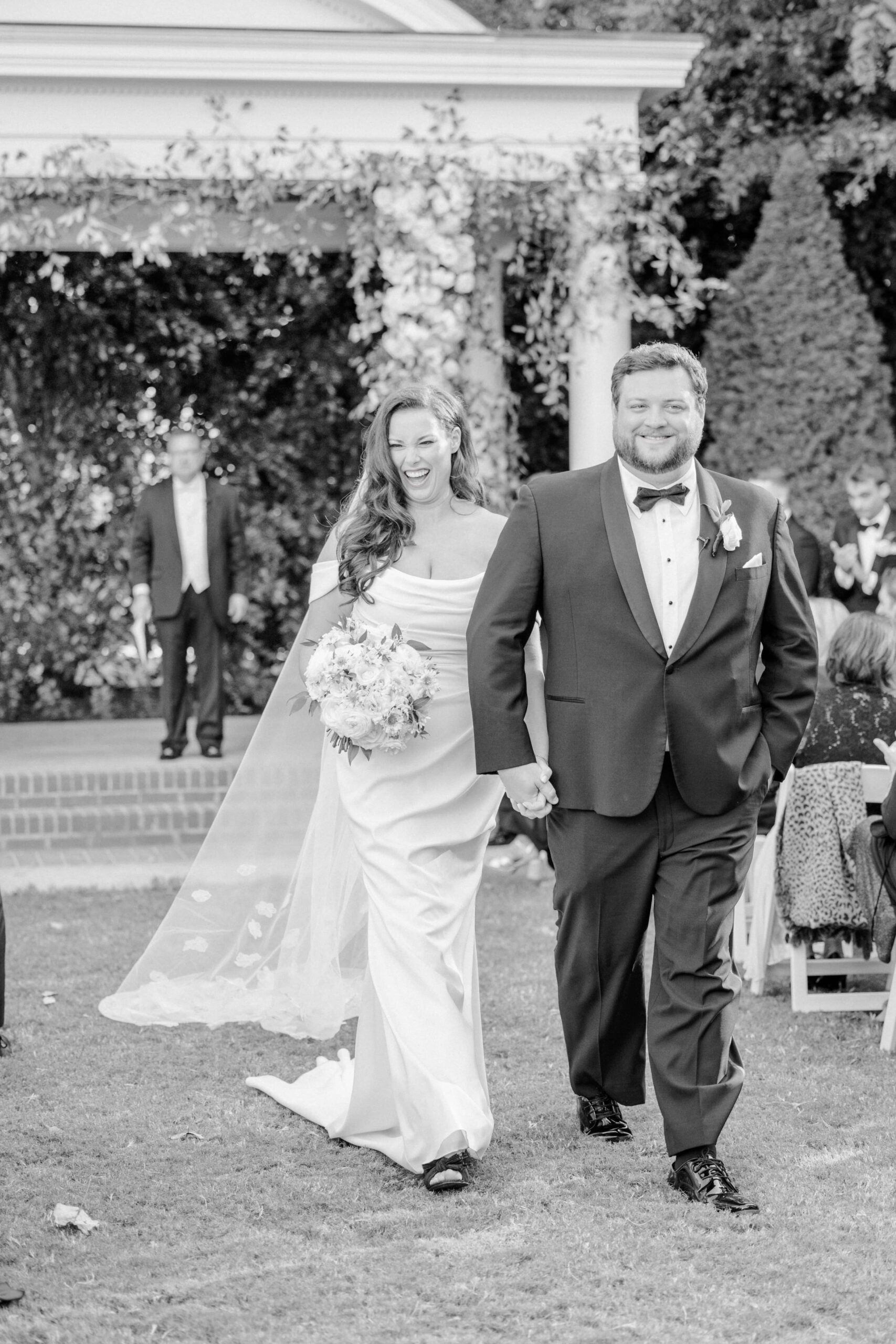 Bride and groom happily walk down the aisle after being married at the Duke Mansion.