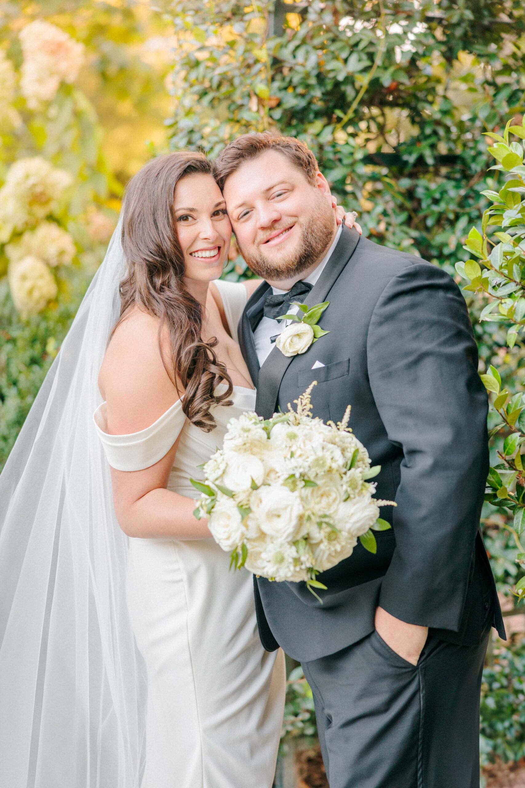 A newlywed couple taking wedding photos at the Duke Mansion.