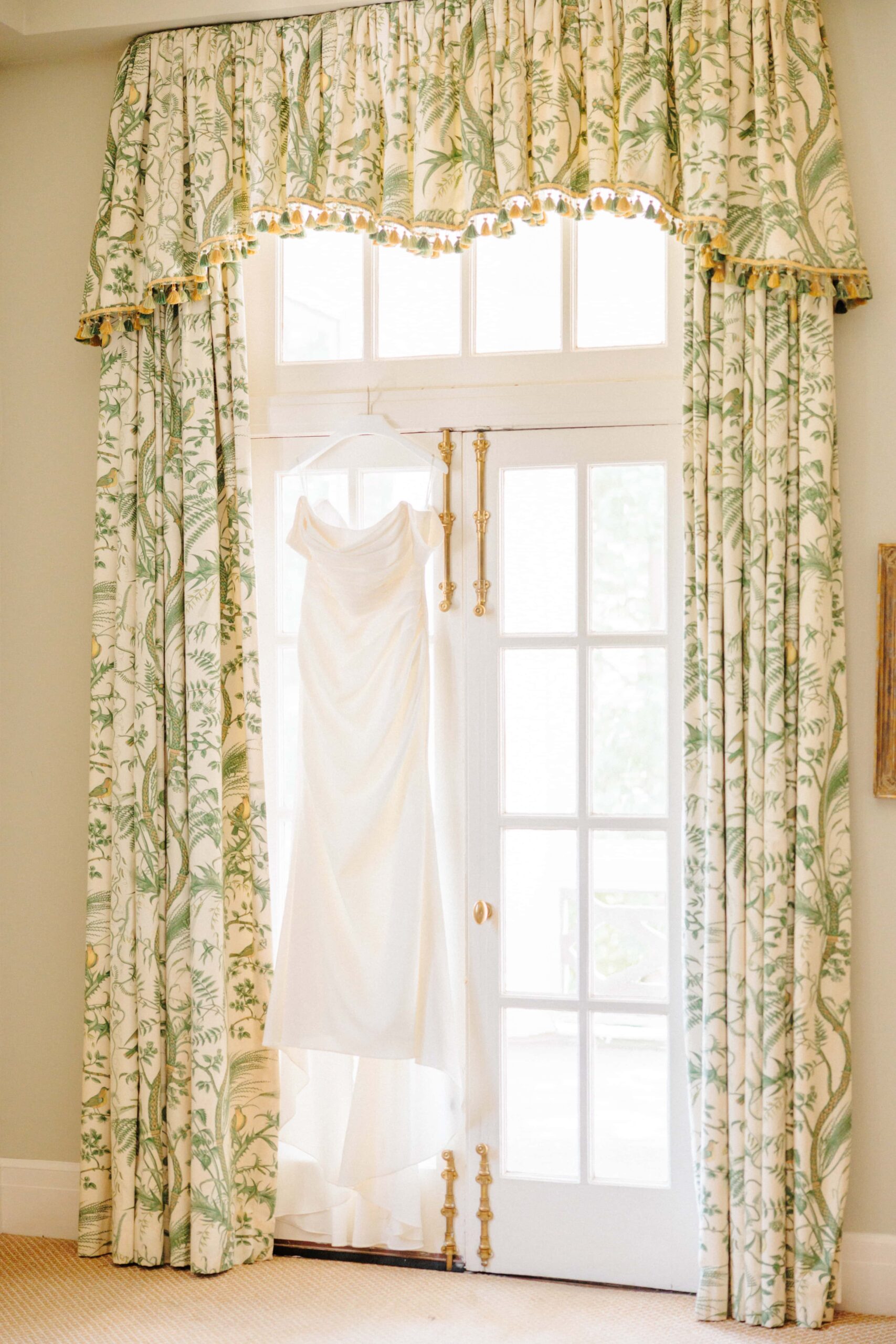 A wedding dress hangs from the valances of the Duke Mansion.