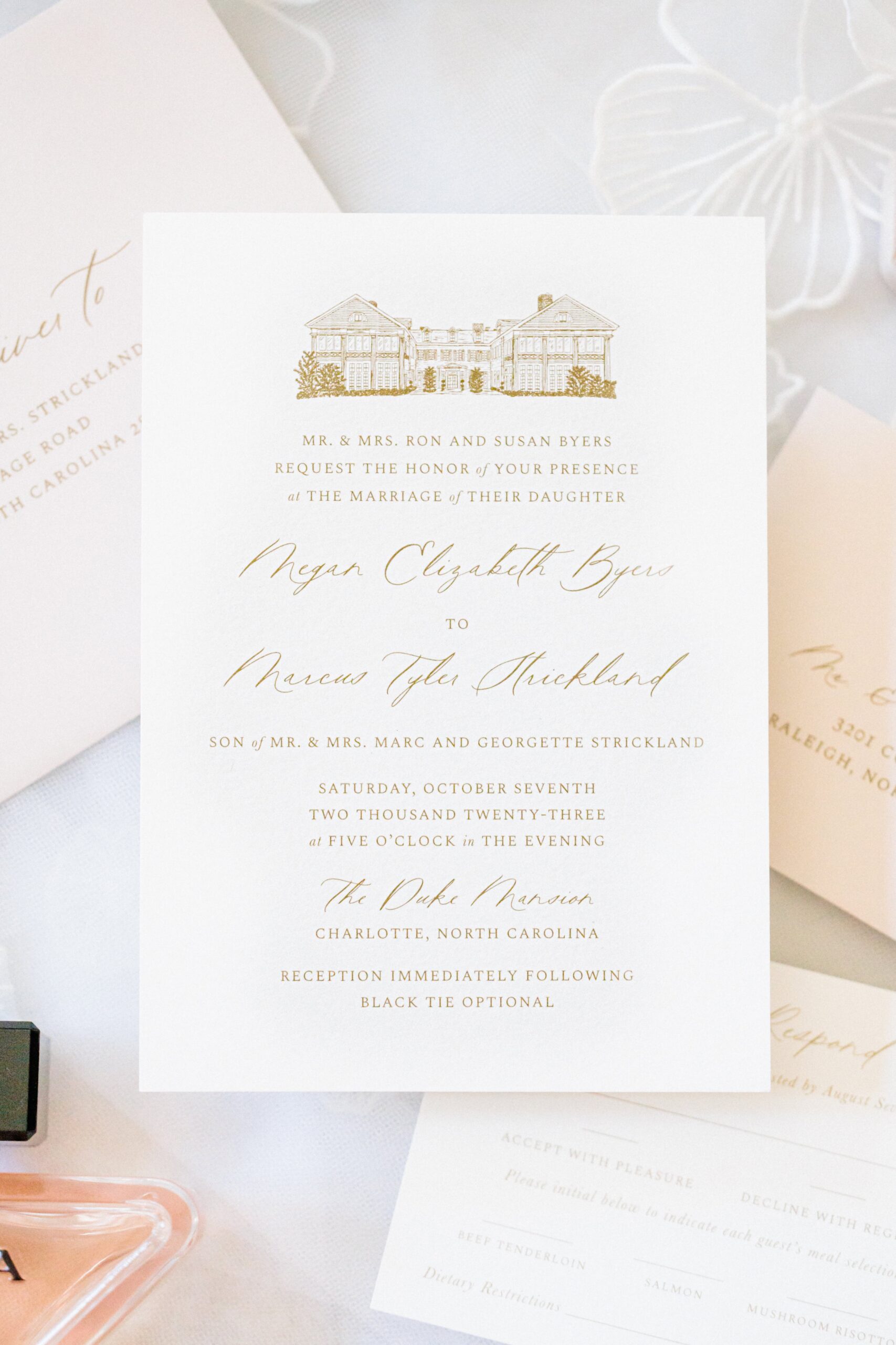 A wedding invitation for Meg and Tyler's wedding at the Duke Mansion in October.